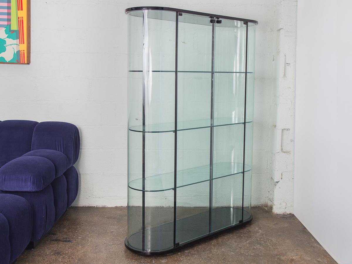 Amazing glass vitrine for Pace Collection. Super sleek, hyper modern 1980s storage cabinet with double doors and ebonized, rounded edges. Very high-quality production. This tall vitrine has three glass shelves that can be removed. Glass is in