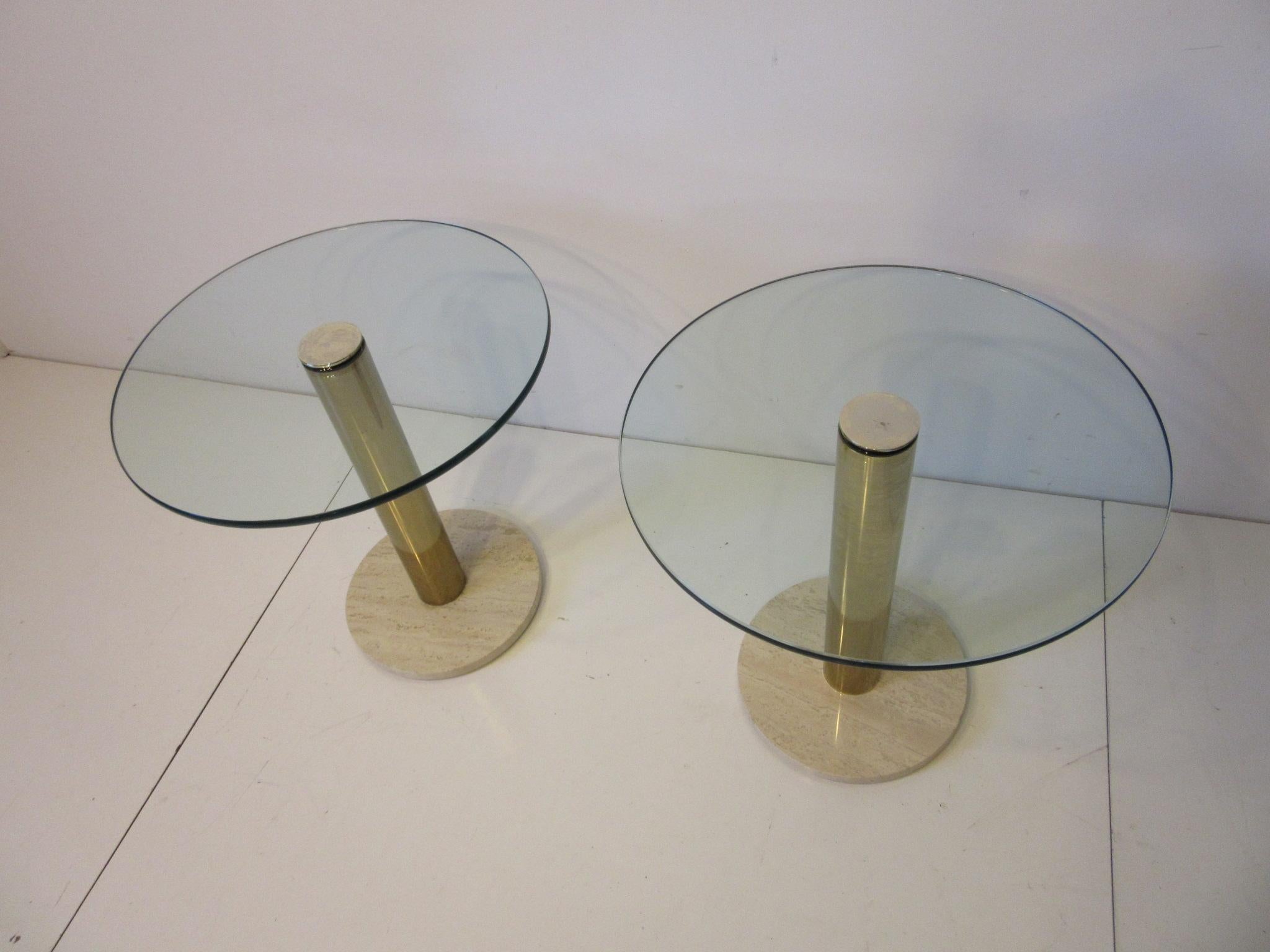 A pair of side tables with glass top having rounded edges, brass base and Italian Travertine marble bottom designed and manufactured by Leon Pace and the Pace Furniture Company. A staple of well designed interiors of the 1970s and 1980s for their