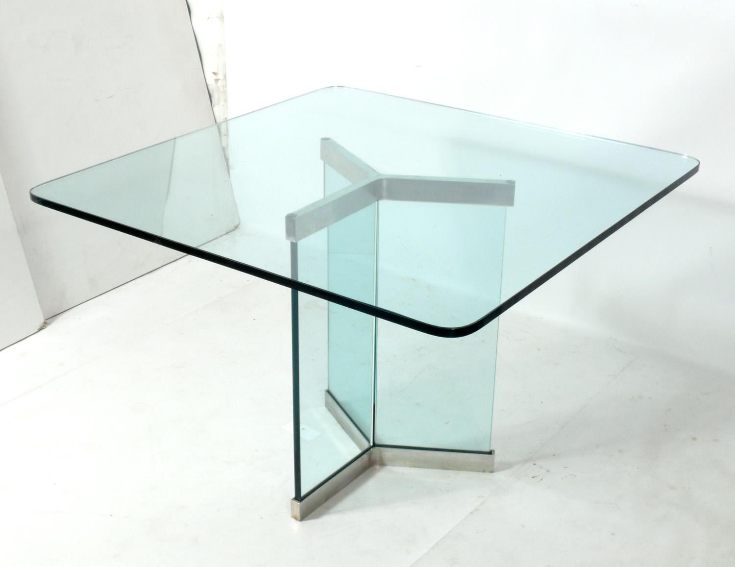 Stainless steel and thick glass Mid-Century Modern dining table, designed by Leon Rosen for Pace, American, circa 1970s.