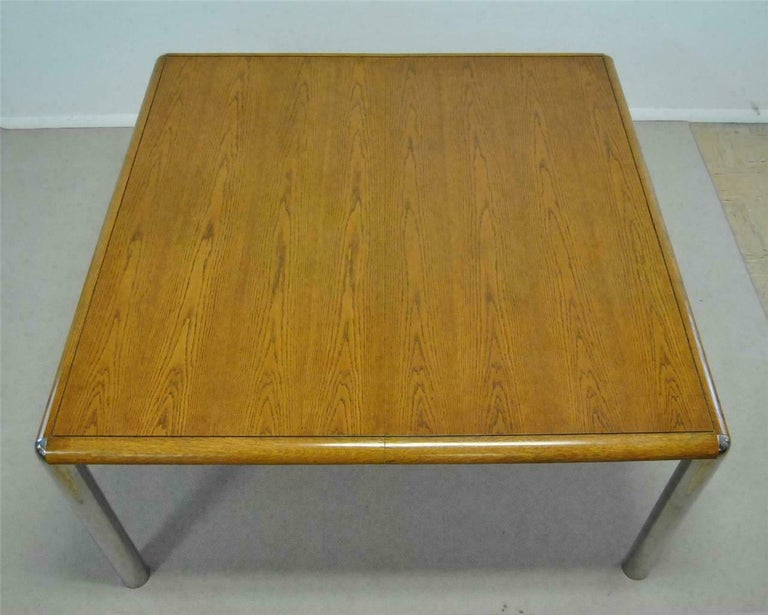 A Classic midcentury dining table. Table is identical to a pace style table but there is no manufacturing label to support this. Tabletop is oak which is supported at each corner by tubular chrome legs. Table is very structural and strong with iron