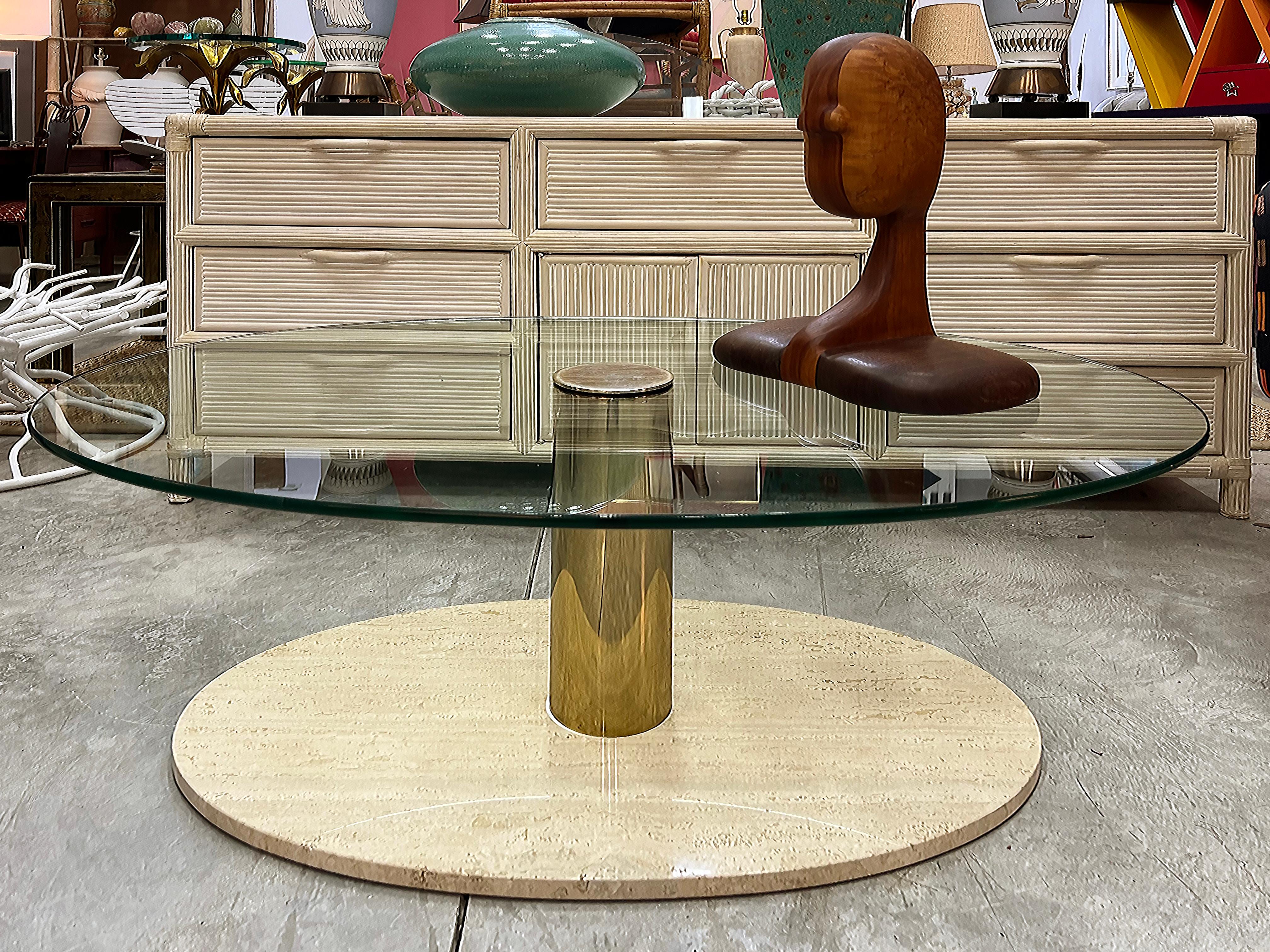 Pace Vintage Postmodern Travertine, Brass Coffee Table with Glass Top

Offered for sale is a vintage Postmodern 1980s Pace coffee table with a travertine base. The table has a substantial oval glass top that is supported by a single brass pedestal.