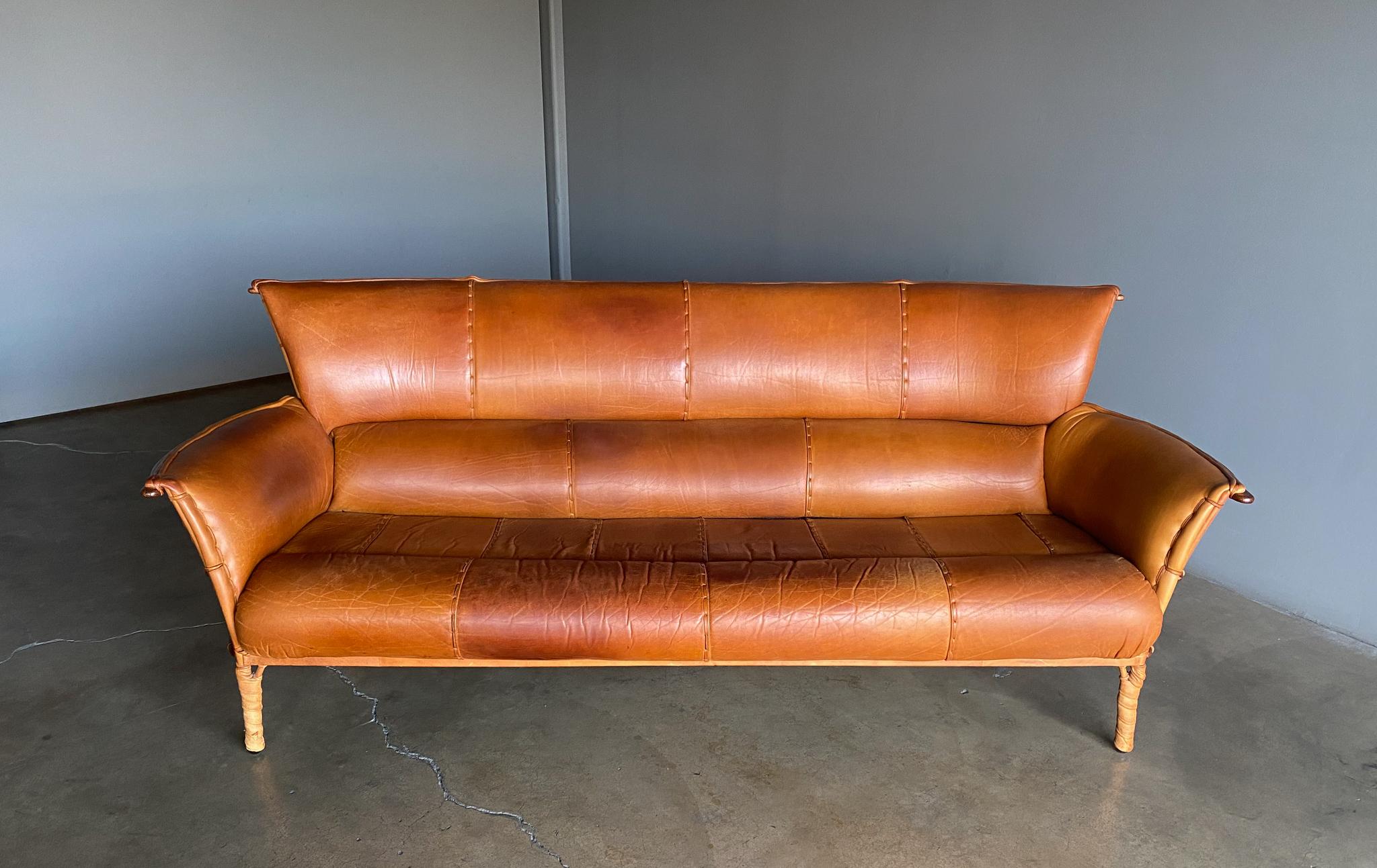Pacific green Cognac leather & palmwood Navajo sofa, 1990's. Original condition with a beautiful patina to the leather.