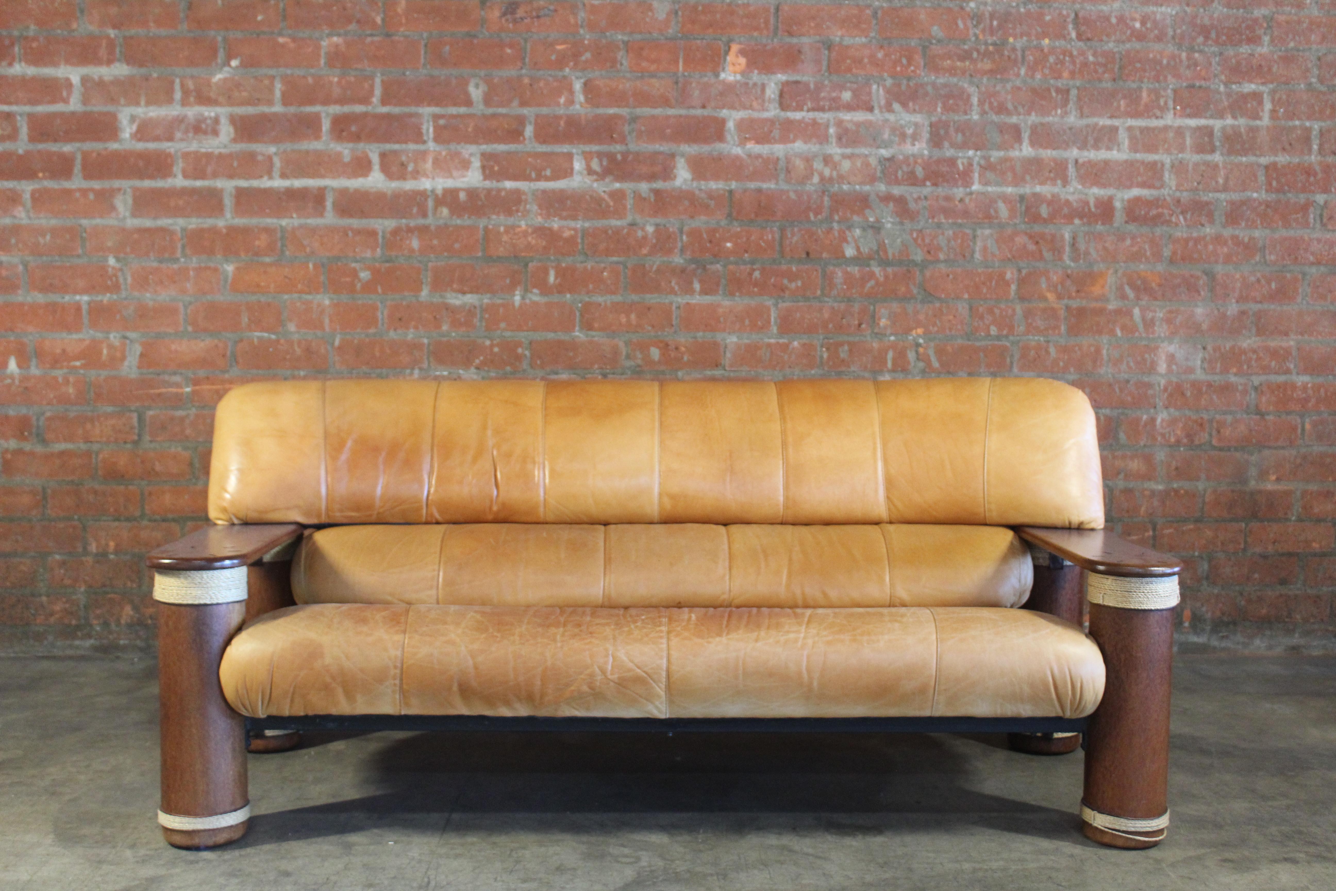 A leather and palmwood sofa with rope detailing made by Pacific Green in the 1990s. In overall good condition with wear and patina to the leather. Matching settee also available.