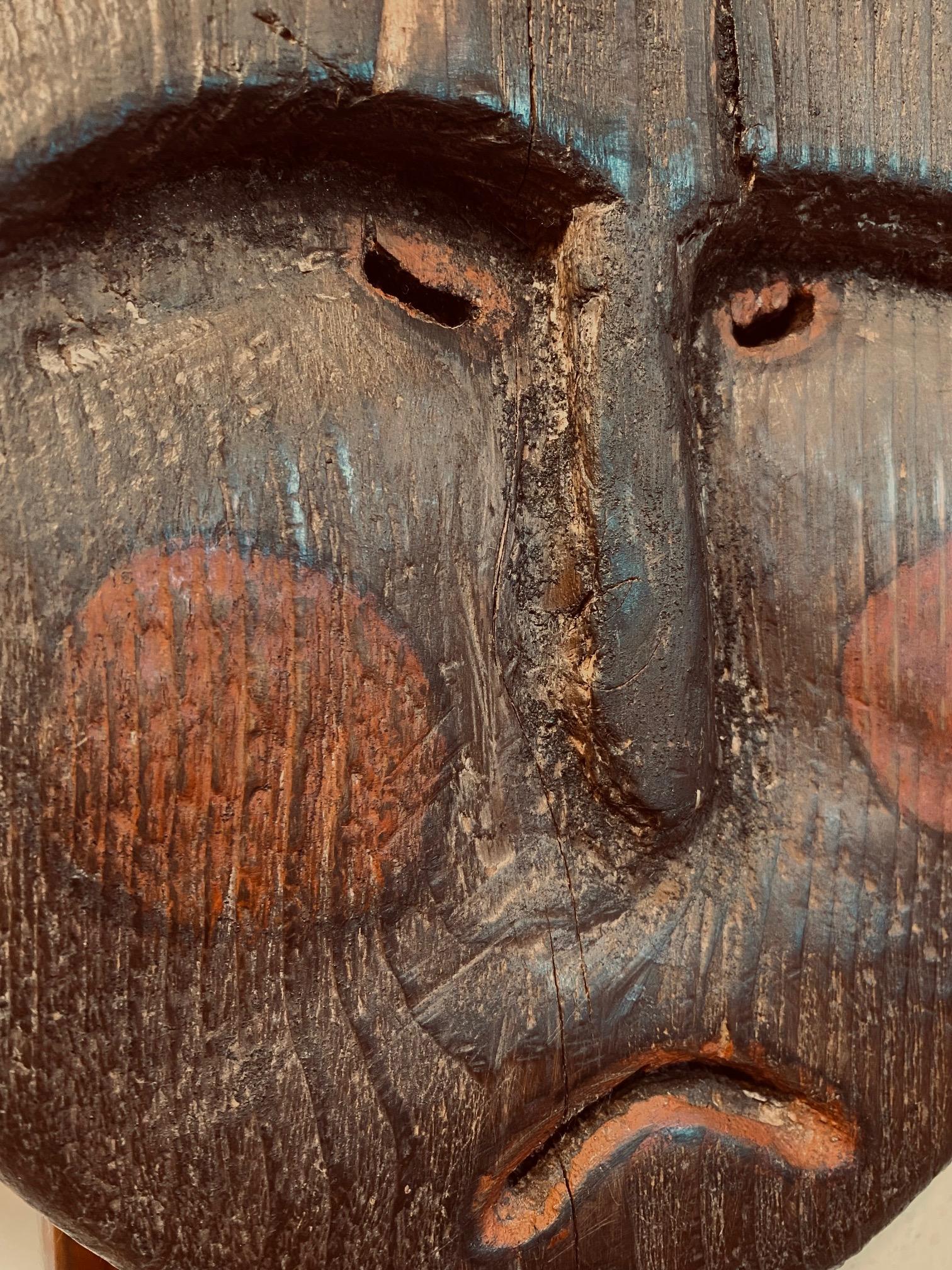 Antique Pacific Northwest Coast Carved and Polychromed Wooden Mask, almost certainly Yup'ik, early 20th Century, an oval wooden face with recess carved eyes and cheeks, bas relief nose, incised open mouth and pierced eyes, in original weathered