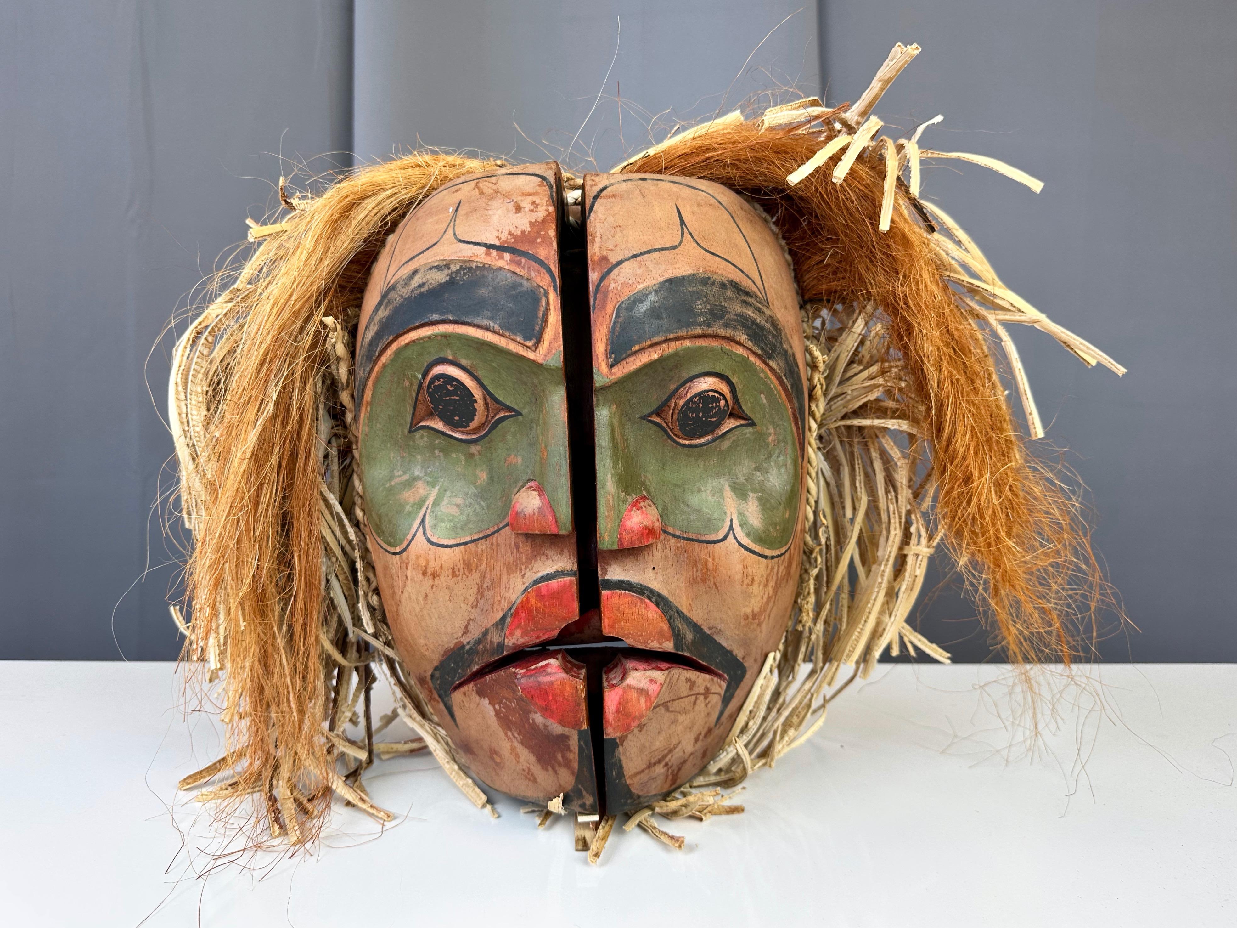 An exceptionally well done and scarce vintage transformation or opening mask in the style of—and likely by—the First Nations Kwakuitl (Kwakwaka’wakw) people of the coastal Pacific Northwest.

Mask features a very striking visage when closed, with