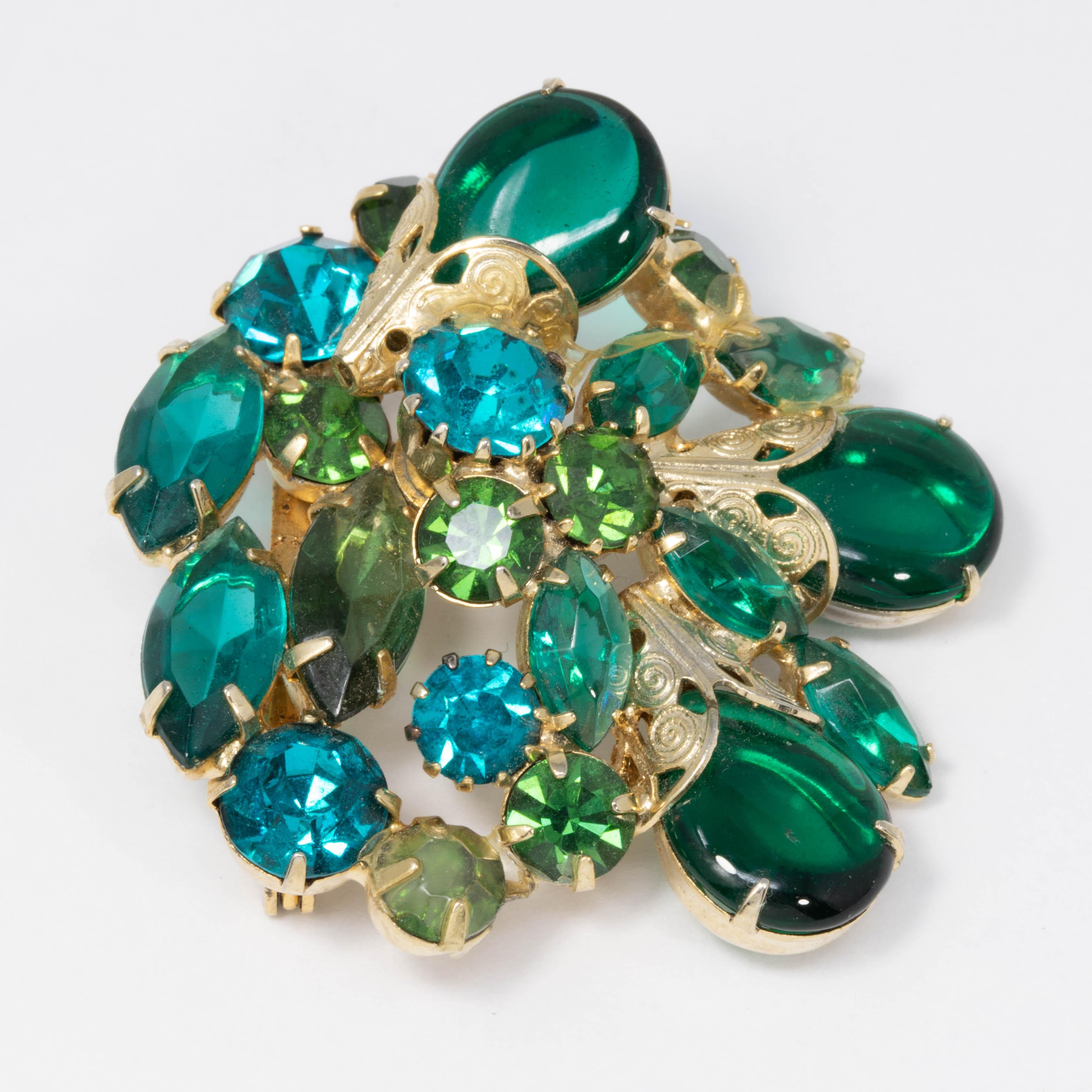 Bold shades of green! Clusters of pacific opal and emerald crystals & cabochons are prong set in this open back goldtone pin brooch.

Mid 1900s.