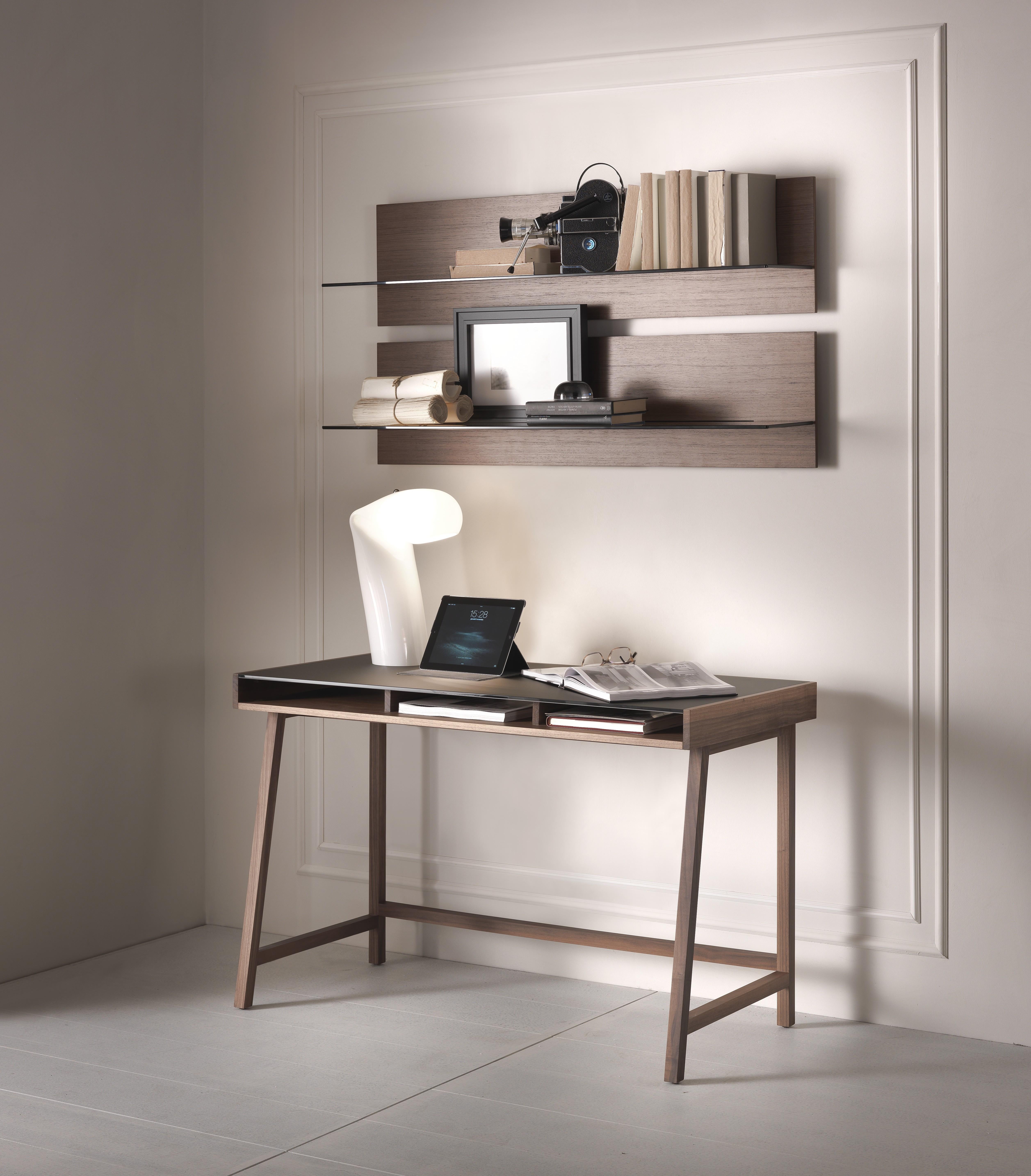 Writing desk with structure in solid Canaletto walnut or ash. Clear or lacquered tempered glass top (black, moka or matte bronze) and shelf veneered Canaletto walnut or ash. 

Fabio Rebosio started to take his first steps into the world of