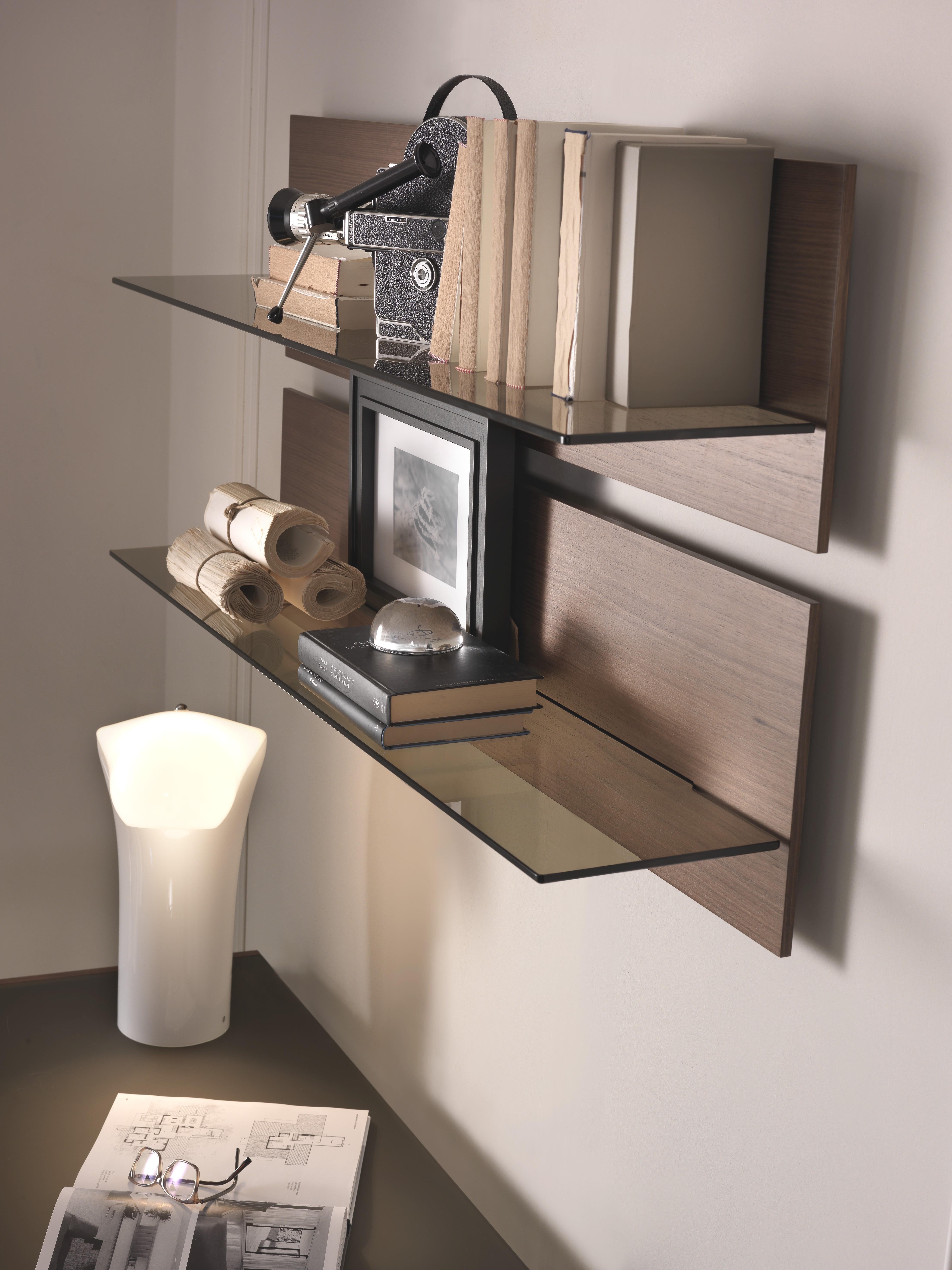 Shelves in veneered ash or fiberboard. Available in tempered clear or transparent bronze glass (8 mm thick). Featured in walnut wood with a transparent bronze.

Fabio Rebosio started to take his first steps into the world of architecture as an