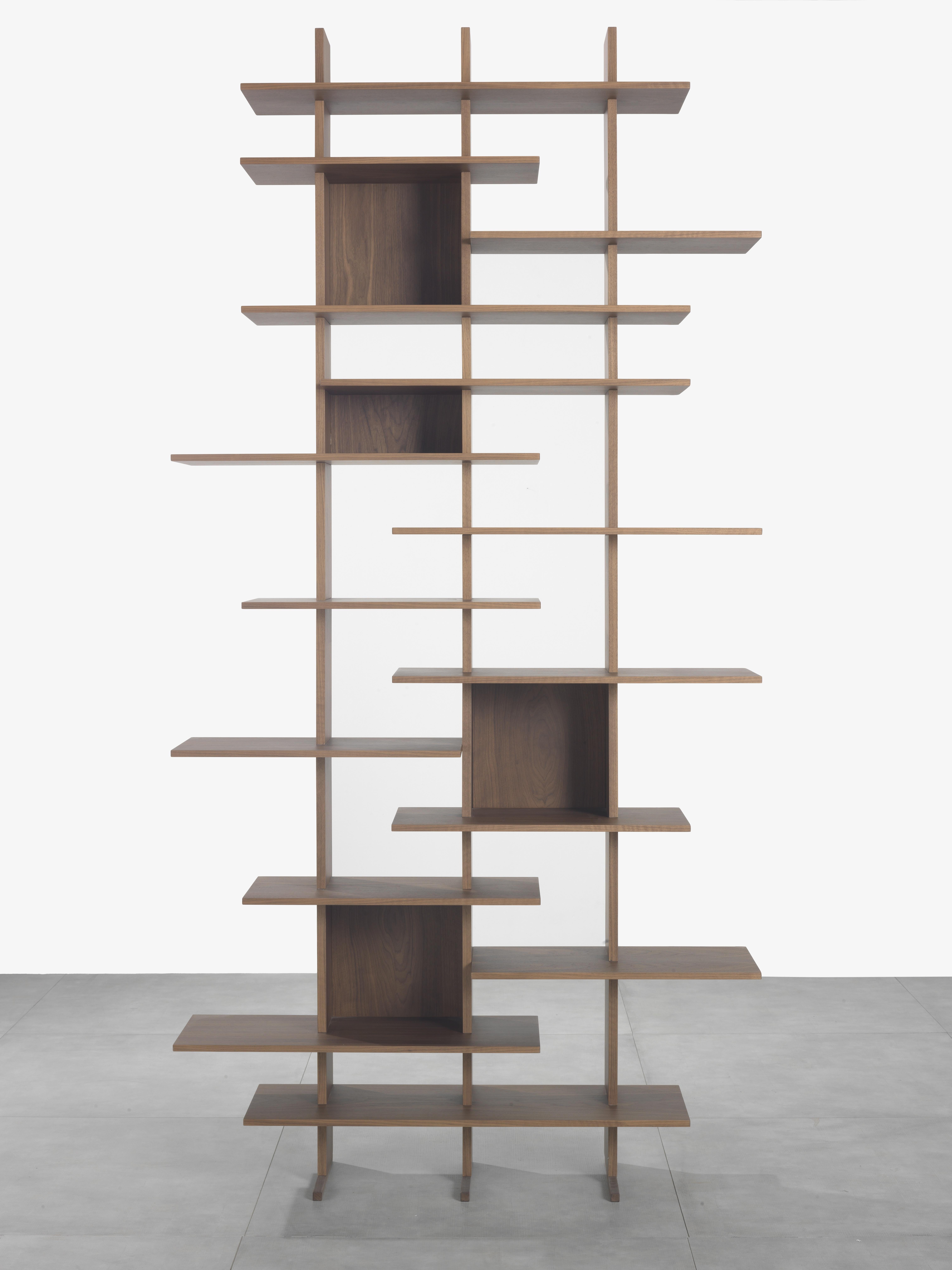 Modular bookcase with veneered Canaletto walnut or in fiberboard. Shelves, frame and supporting back panels in veneered Canaletto walnut or in fiberboard. Cod. 5549.192: possible assembling as corner. Cod. 5549.256: available to be hung to the wall