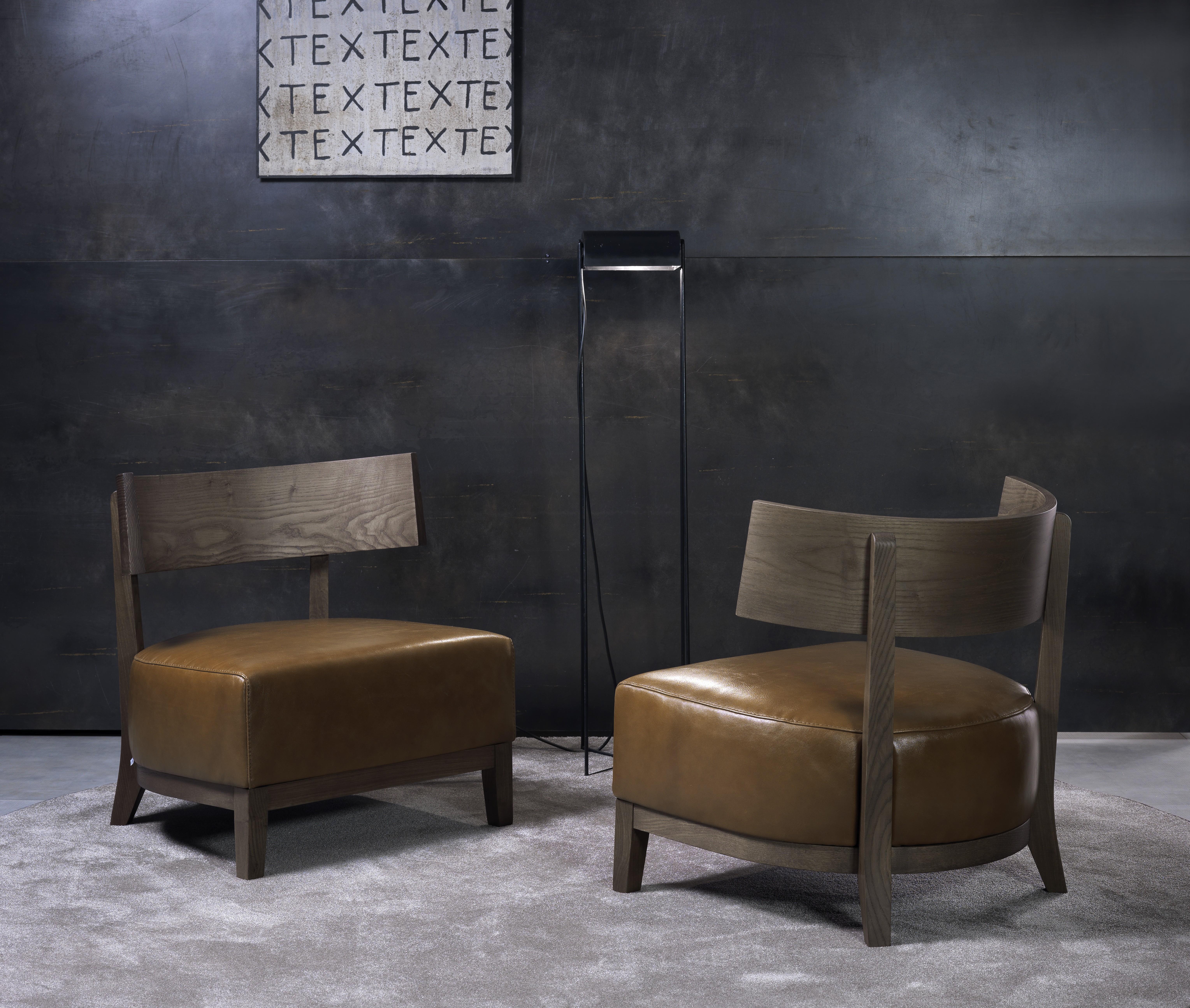 Small armchair with solid ash structure, covered in leather, eco-leather or fabric of the collection.