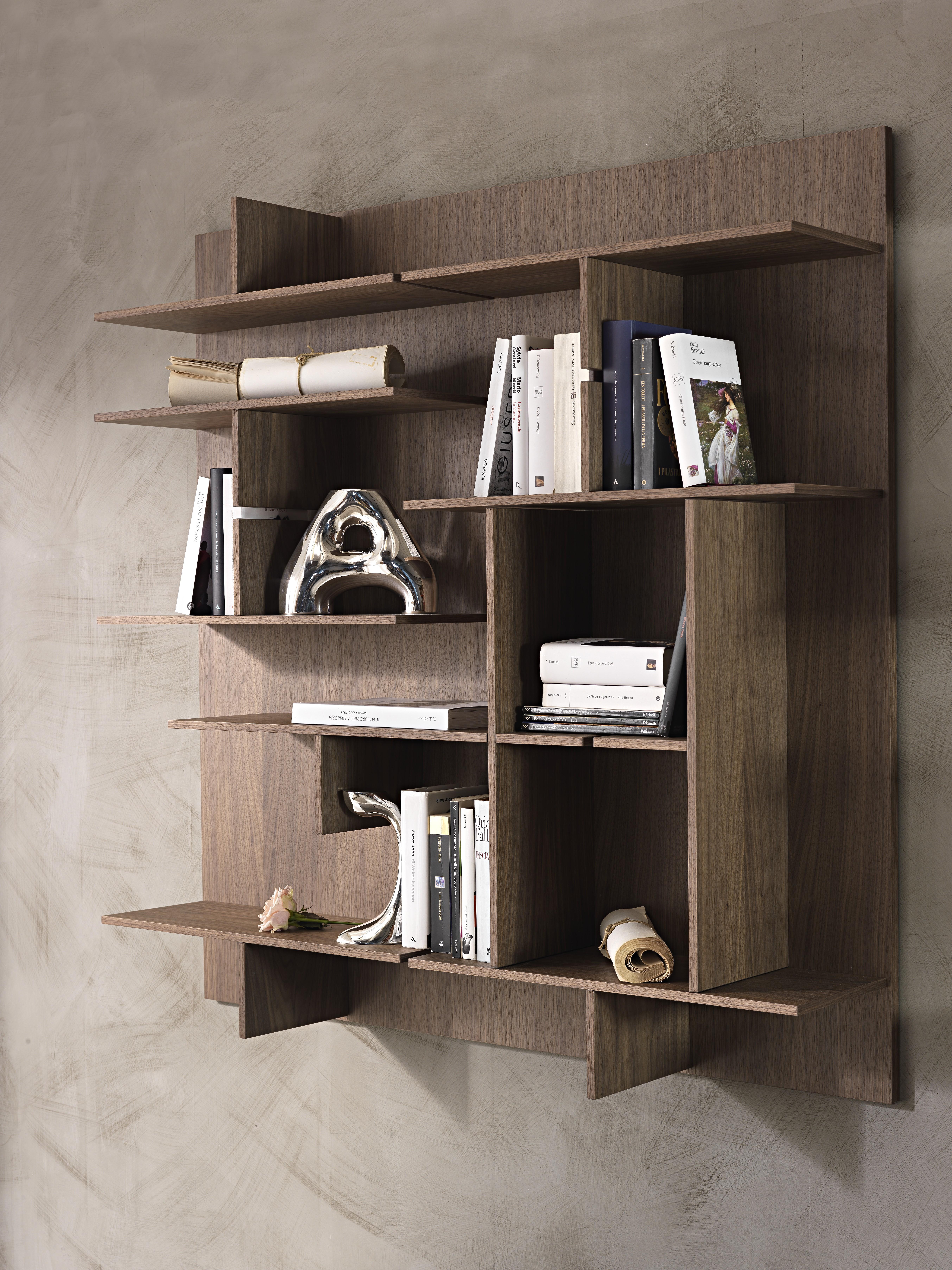 Modular wall bookcase with structure veneered Canaletto walnut or fiberboard. It is possible to hang it vertically or horizontally. Available finishing’s: NK Canaletto walnut, closed pore matte lacquered ( L1 white, L19 pearl, L3 cappuccino colour,