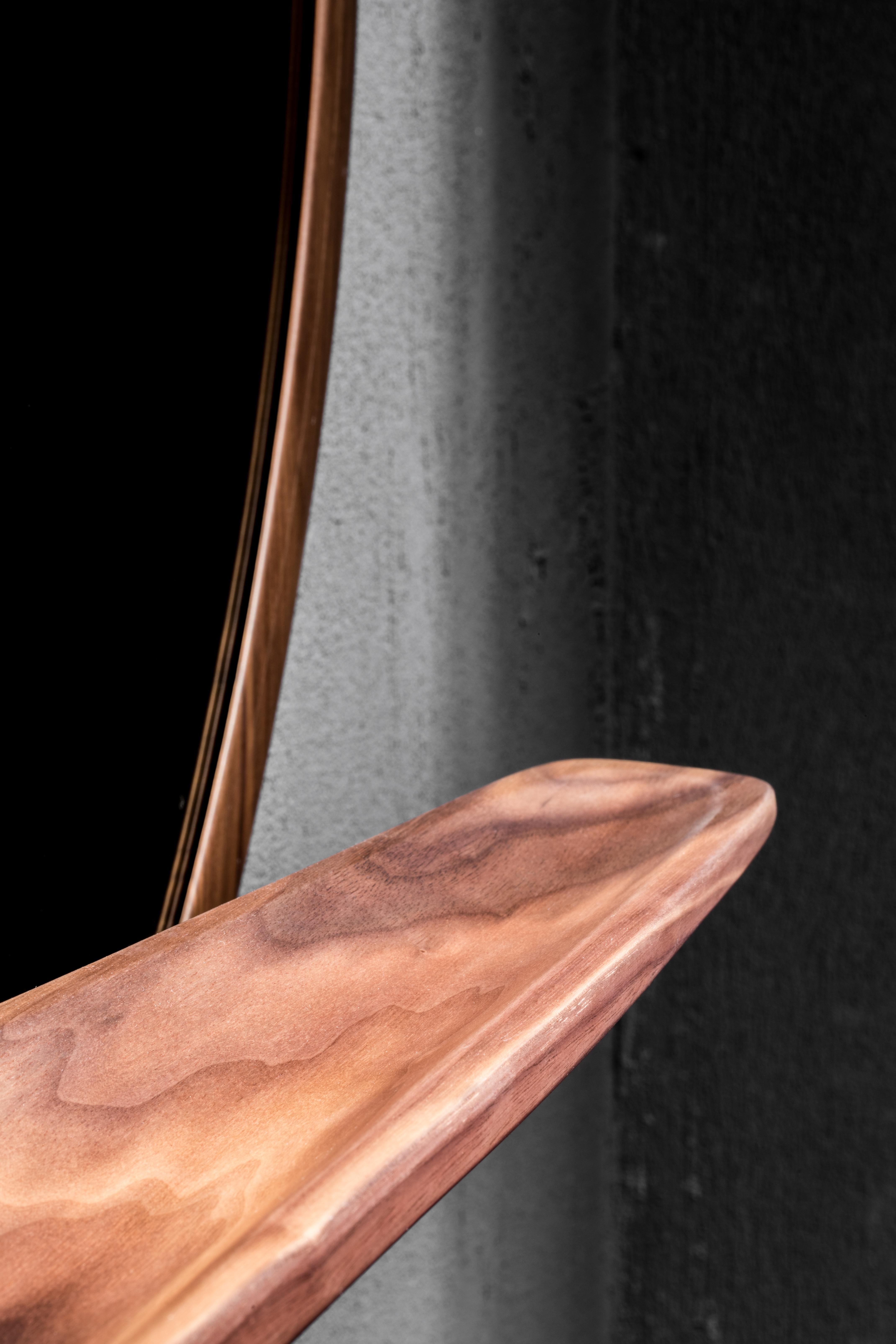 Wall mirror with frame in solid Canaletto or ash. On request shelf in solid ash or Canaletto walnut. Available finishings: WG wengé, NC walnut, TB tobacco, NK Canaletto walnut, TN ash stained black, open pore mattee lacquered.

Stefano Bigi studied