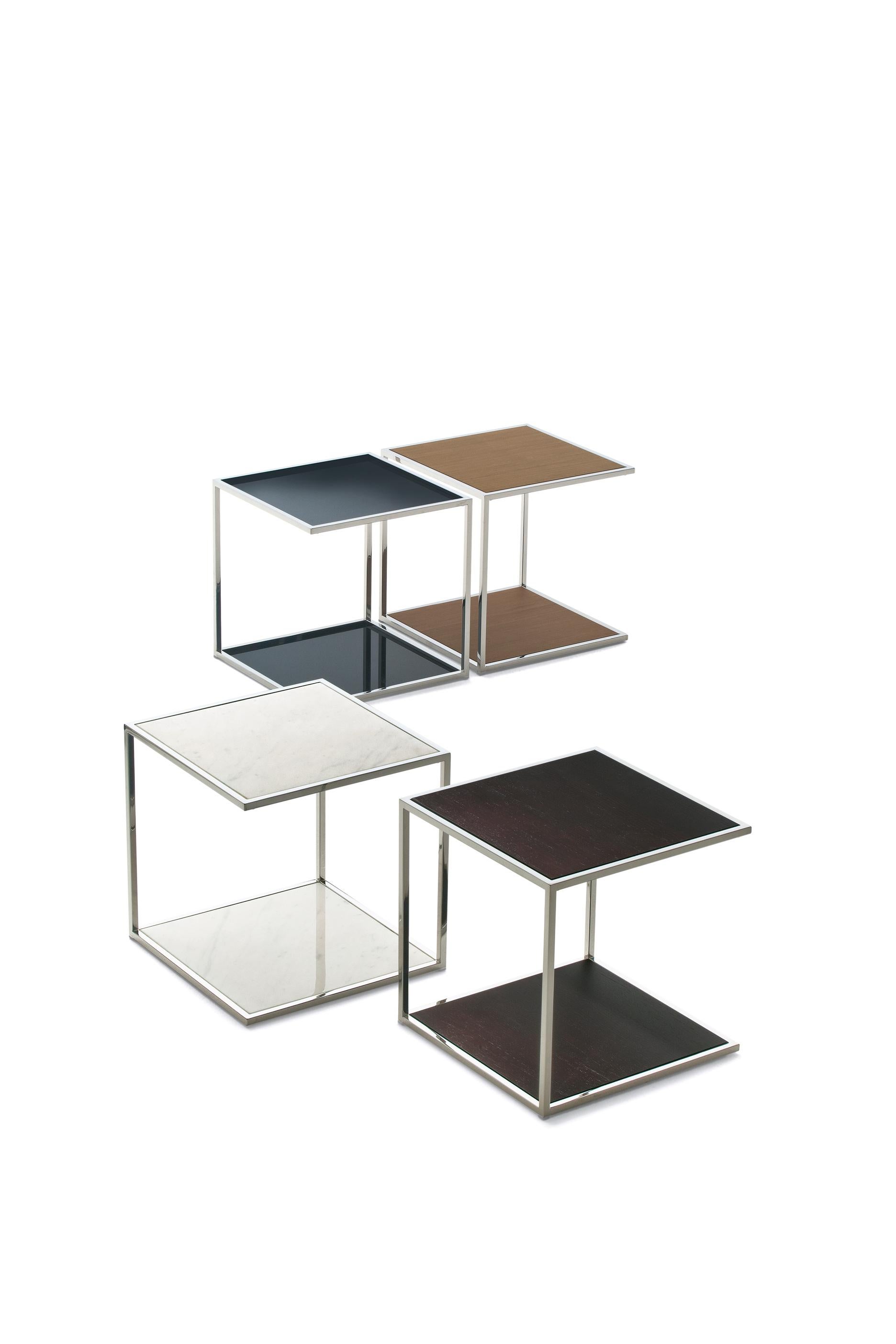 Serving coffee table with structure in chrome-plated metal. Tops veneered in ash, in lacquered glass (extra light white, black or moka) or in polished marble.