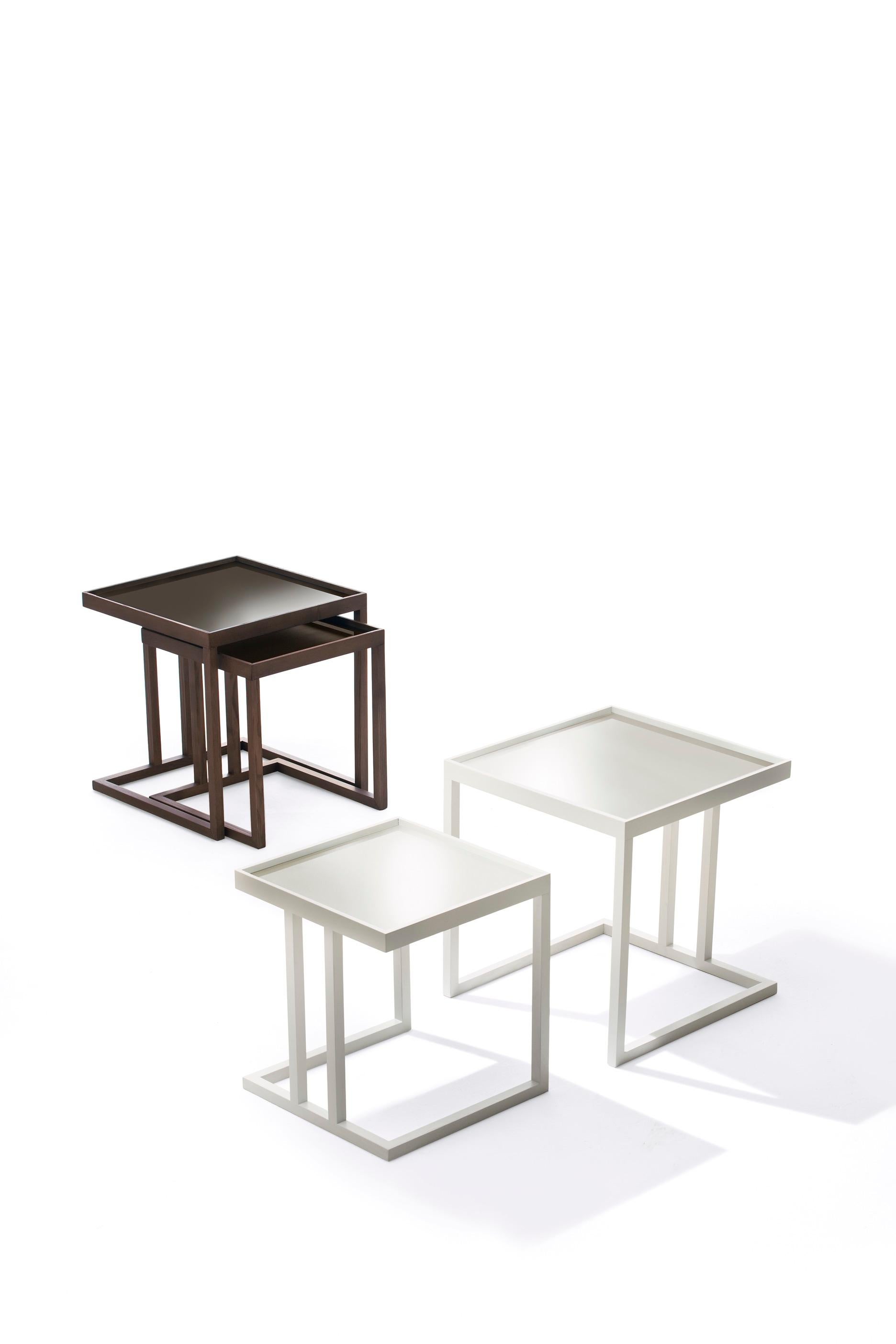 Pair of coffee tables with structure in solid ash. On request, tops in lacquered glass (extra light white, black or mocha).