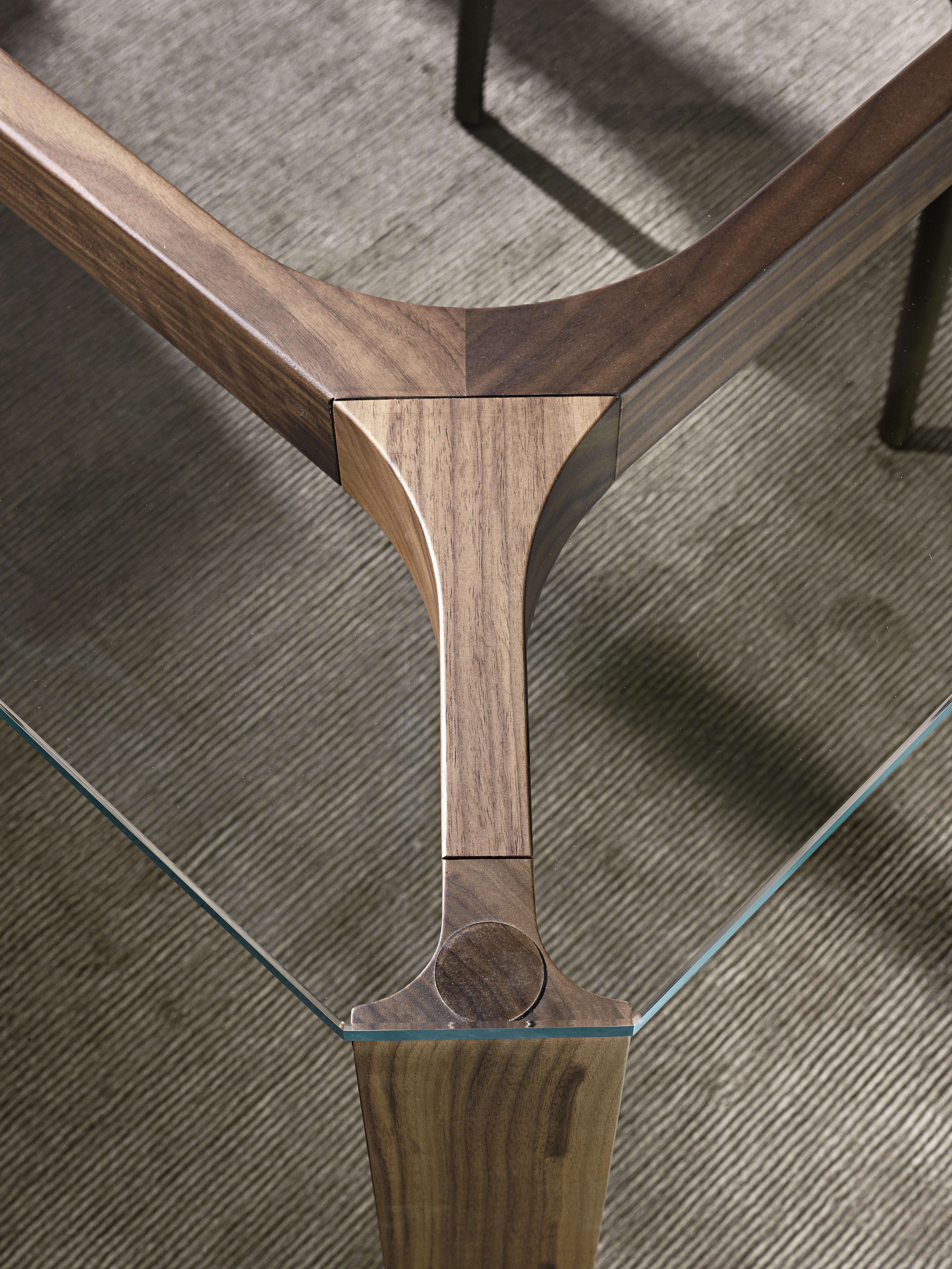 Dining table with structure in solid Canaletto walnut and top in clear tempered glass (10 or 12 mm th). Available finishing’s: wengé, Canaletto walnut.

Norberto Delfinetti and Monica Bernasconi found their studio in 2004. Despite their different