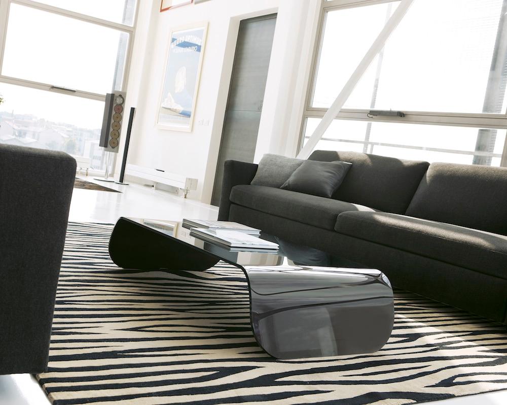 Bridge-shaped coffee table in curved glass (3/8” thick), clear or lacquered black.

Black glass version also available at $1531. 