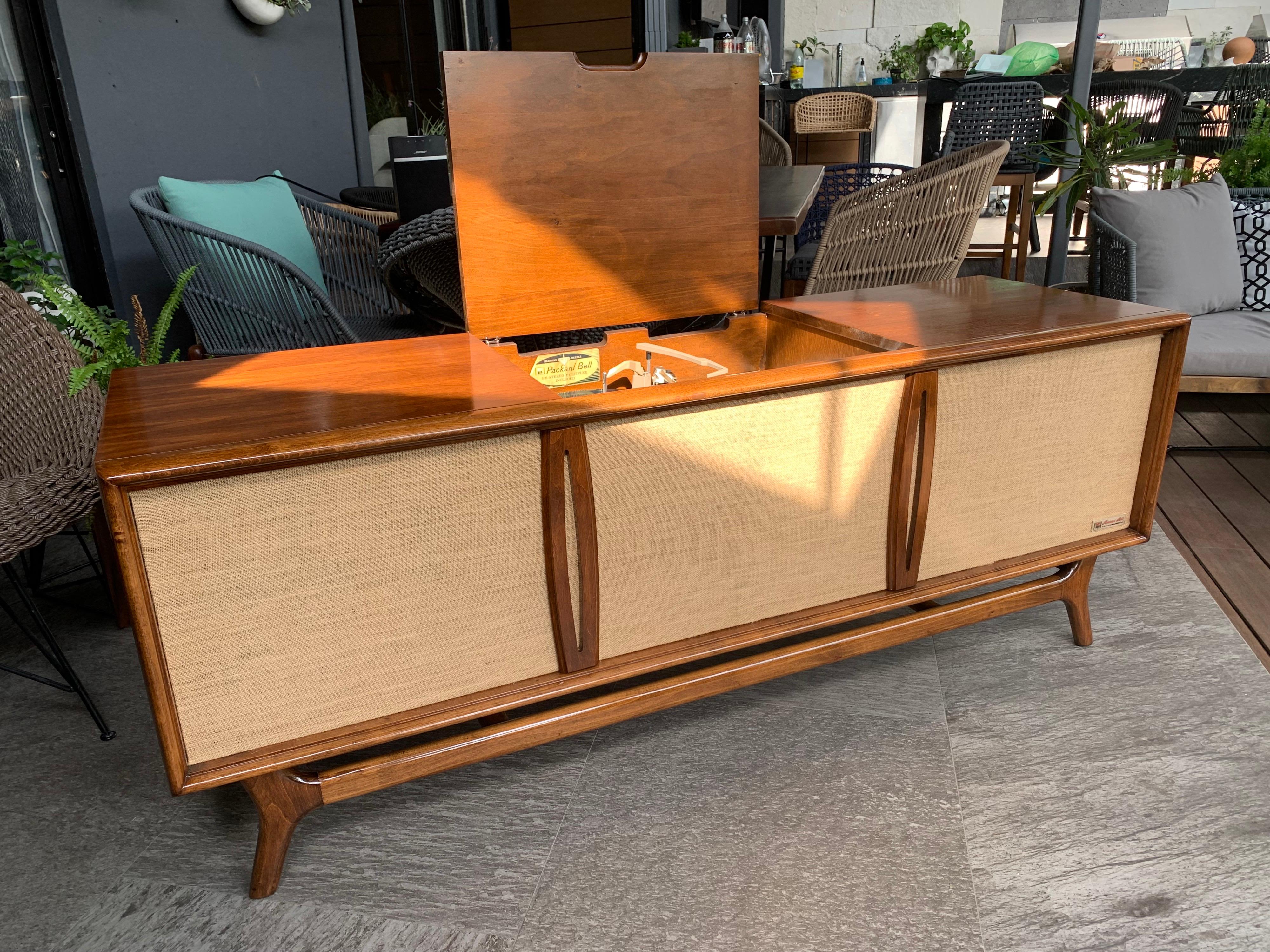 Spectacular midcentury console made in the 1960s, mahogany wood, the original system we believe does not work. The entire exterior and interior was professionally restored.