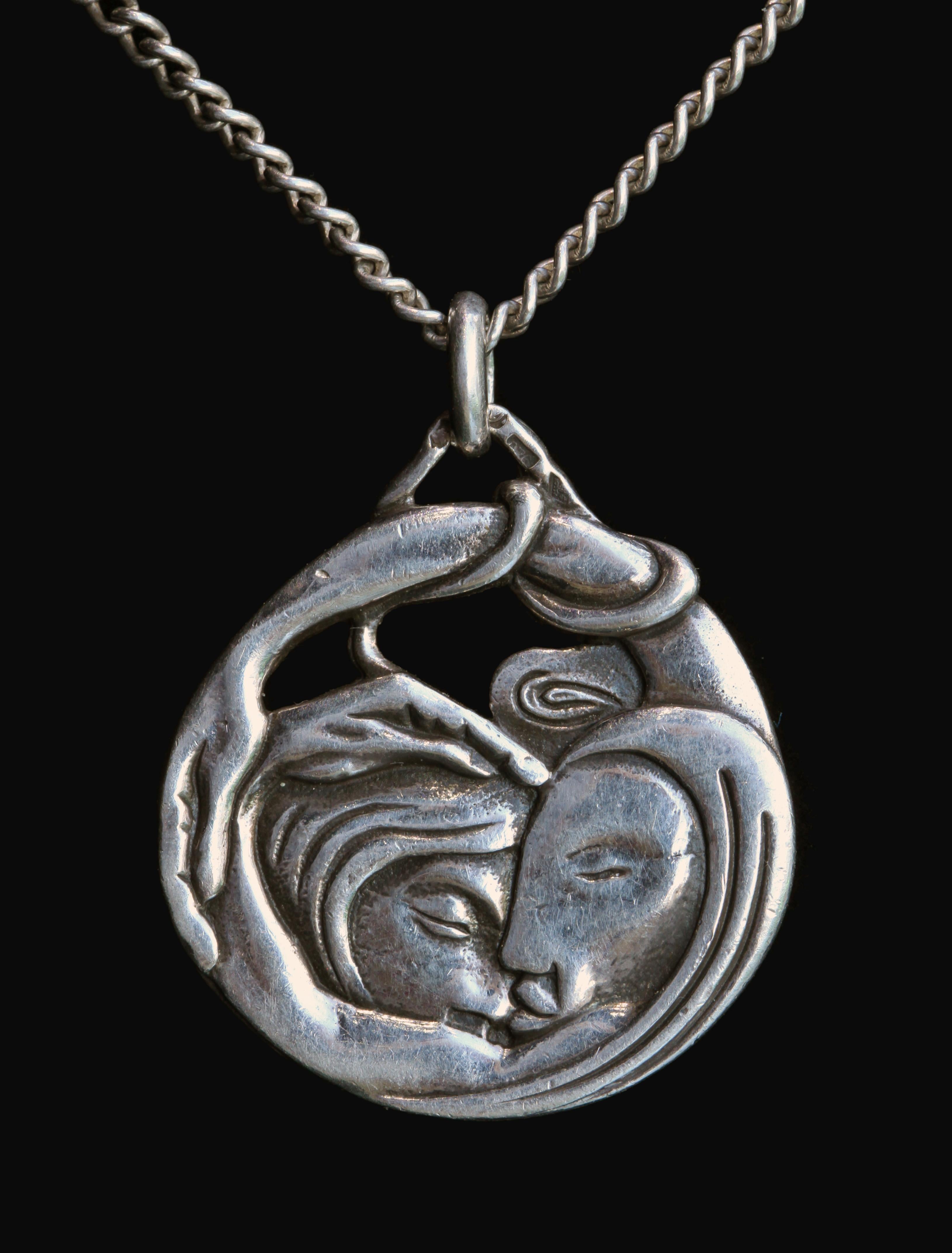 Masterful portrayal of Leda & The Swan by the sculptor Paco Durrio. This symbolist pendant shows the God Zeus having transformed himself into a swan in order to seduce the beautiful Queen Leda. The reverse shows a rarely depicted portrayal of Zeus &