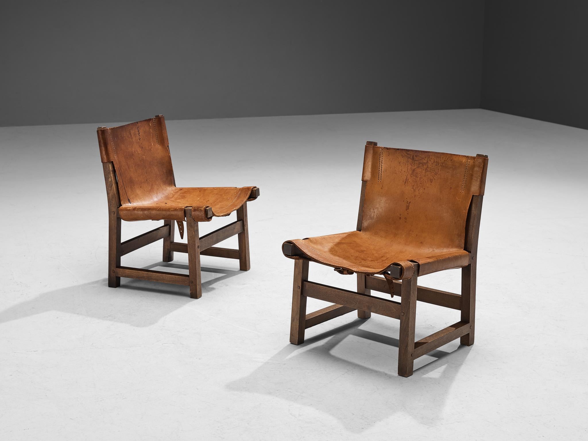 Paco Muñoz for Darro, pair of 'Riaza' chairs for children, walnut, leather, metal, Spain, 1960s

This robust low lounge chair, designed by Paco Muñoz in the 1960s, exemplifies the classic hunting chair style. Its design features leather that is