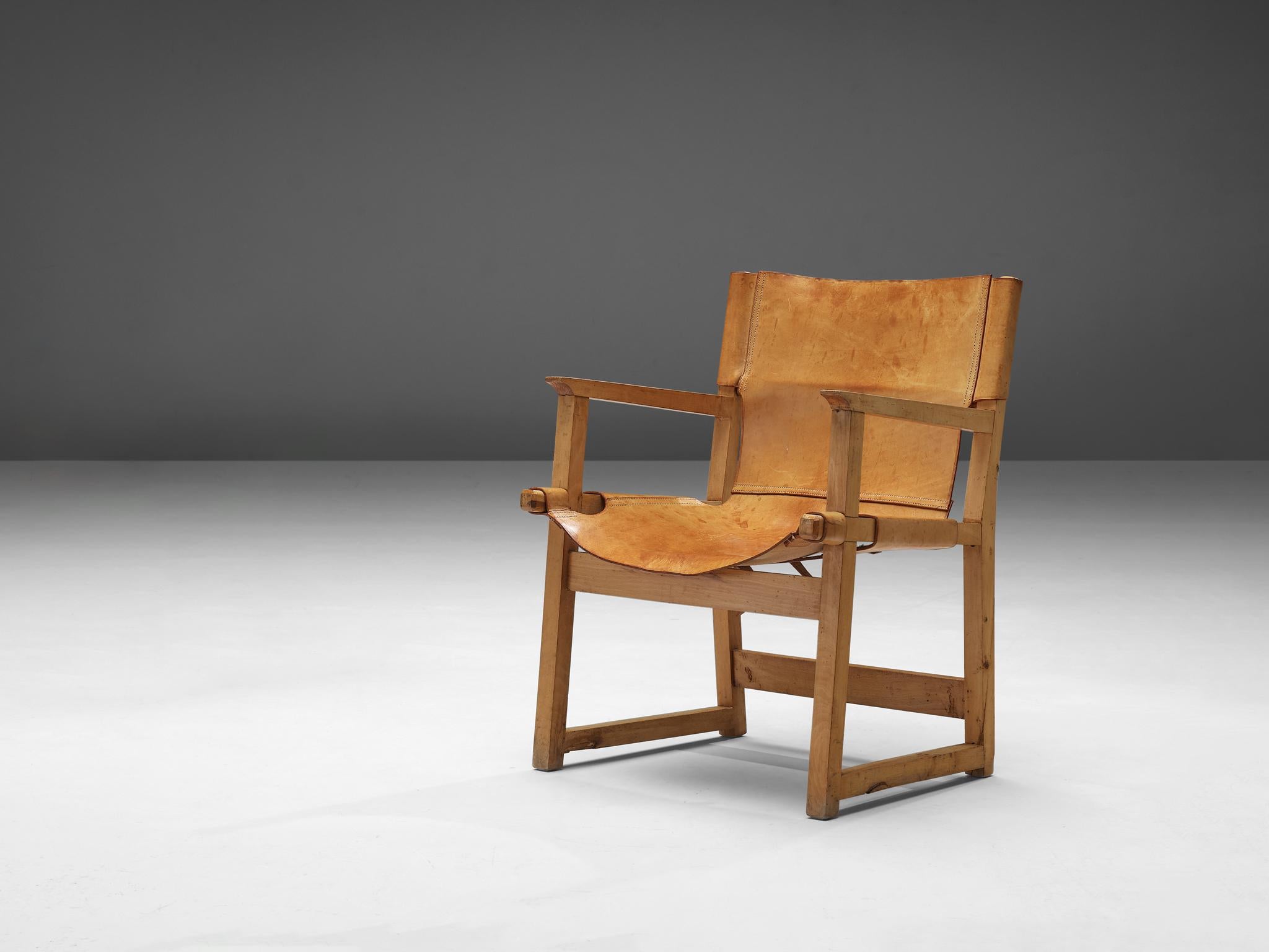 Paco Muñoz, armchair, leather, beech, Spain, 1950s

Midcentury Safari or ‘Riaza’ armchair by Spanish designer Paco Muñoz. This chair is made of high quality saddle leather with removable buckles underneath the seating. The leather has aged elegantly