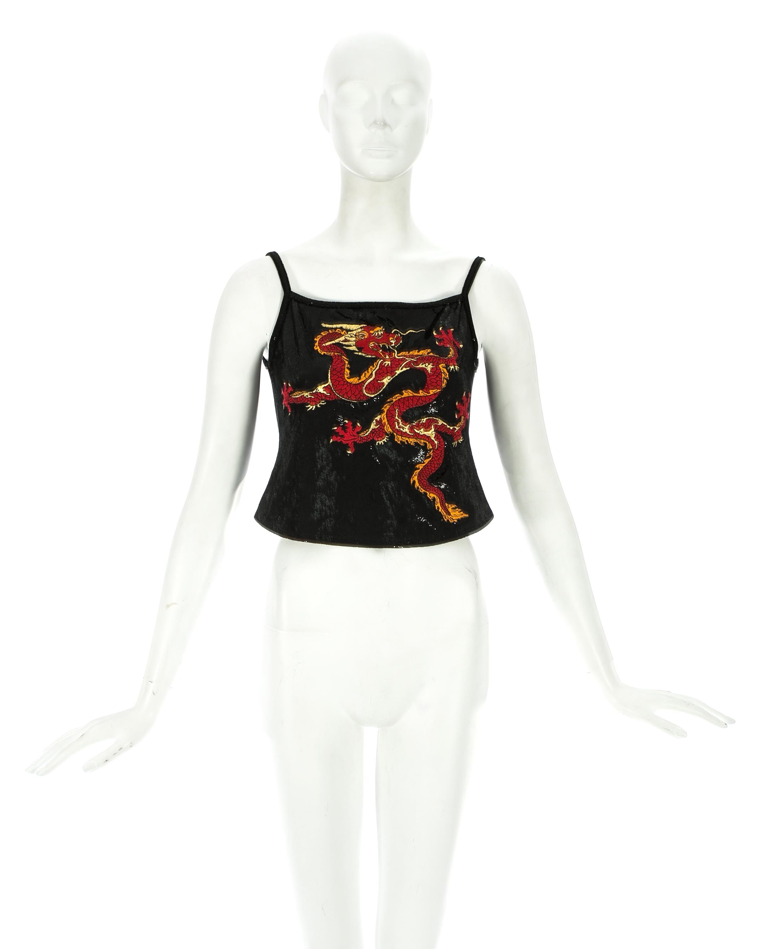 Paco Rabanne; black acetate cropped vest in a reptile skin effect with an embroidered dragon on the front

Fall-Winter 1997