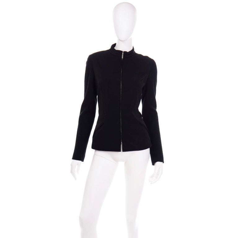This is a great Paco Rabanne zip front jacket with diagonal hip pockets and ribbed sleeves. The jacket is lined and is made of 93% rayon, 11% nylon and 6% elastane. This classic piece can be added seamlessly to any wardrobe and is labeled a size 42.