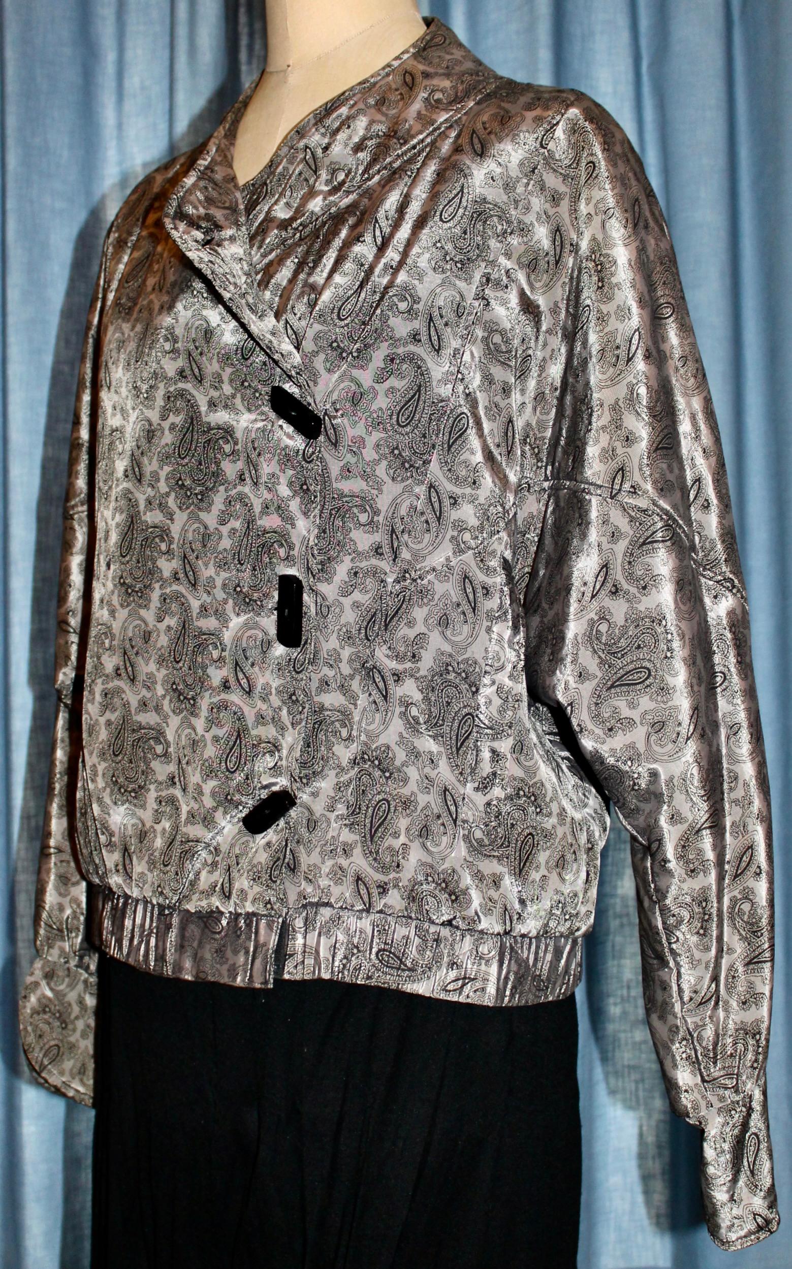Black on grayish silver 'Persian' Design.  Padded shoulders. Black rectangular plastic buttons. EU 40-42 approx.
