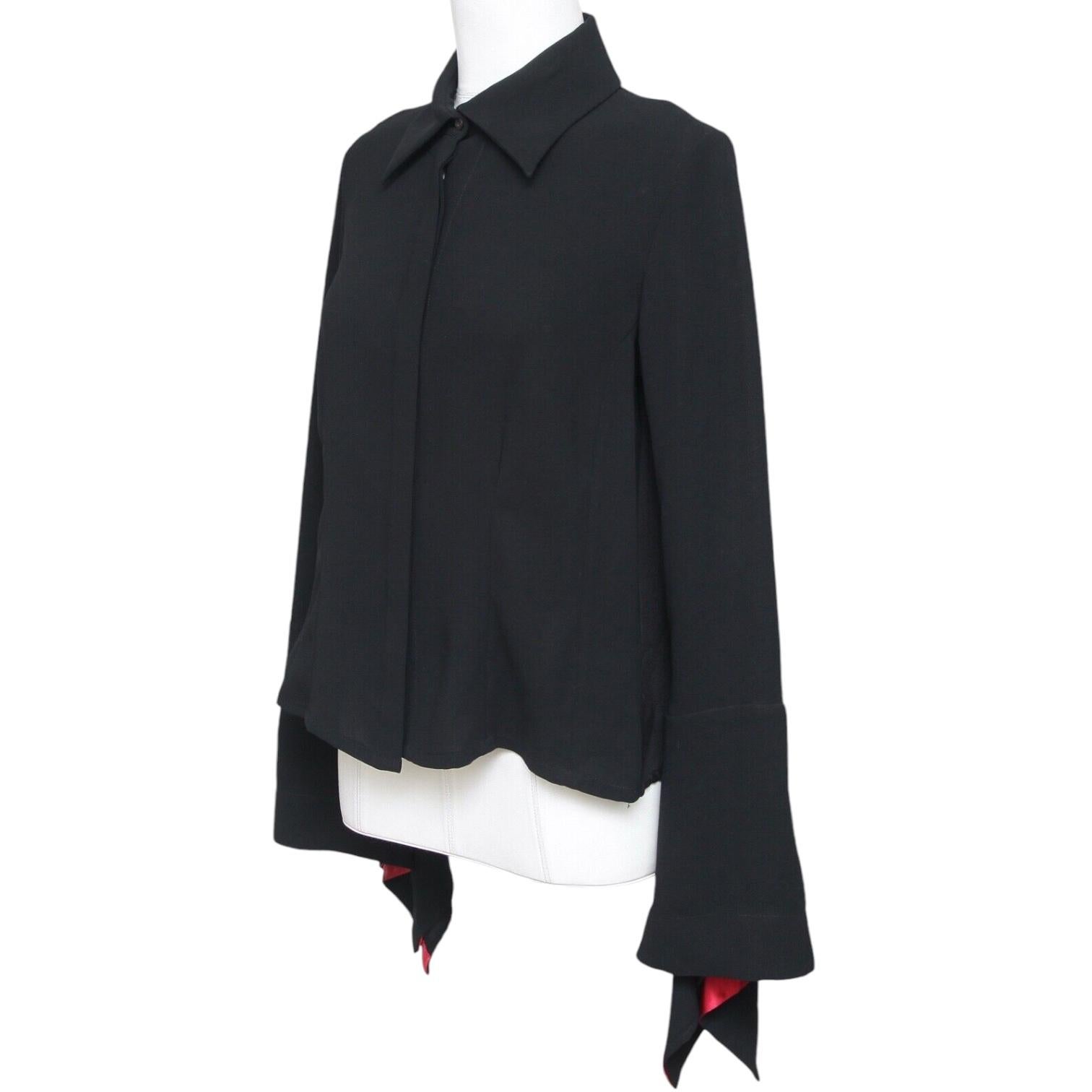 GUARANTEED AUTHENTIC PACO RABANNE VINTAGE BLACK BUTTON DOWN BLOUSE

Design:
- Black button down long sleeve blouse.
- Flared at cuff with red lining accent.
- Pointed collar.
- Unlined.

Size: 40

Fabric: 100% Polyester

Measurements (Approximate,