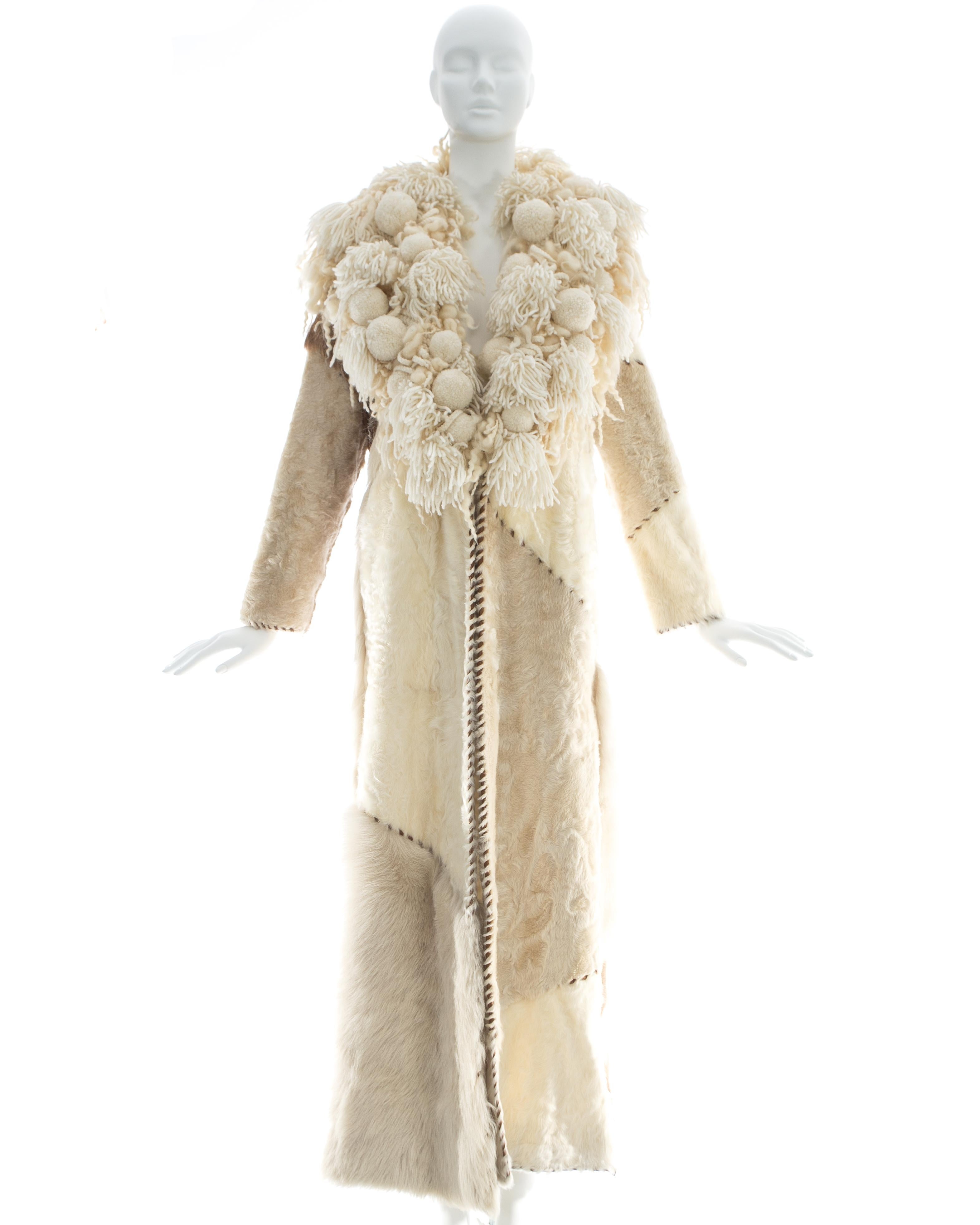 Paco Rabanne; Sheepskin, goat, and pony hair patchwork full length coat with brown leather blanket stitch trim and oversized knitted wool collar

Fall-Winter 2002