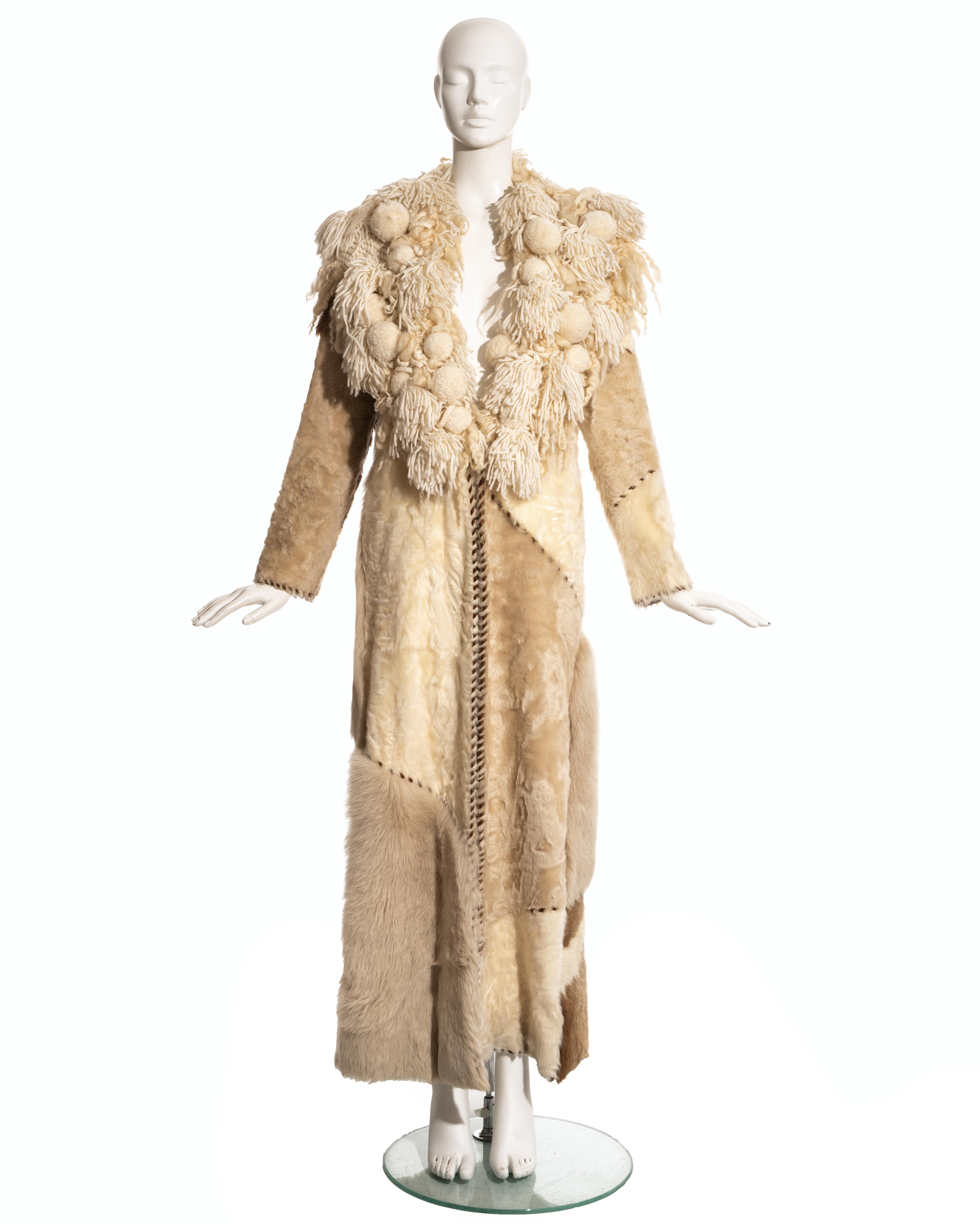 Paco Rabanne sheepskin, goat, and pony hair patchwork full length coat with brown leather blanket stitch trim and oversized knitted wool collar.  

Fall-Winter 2002