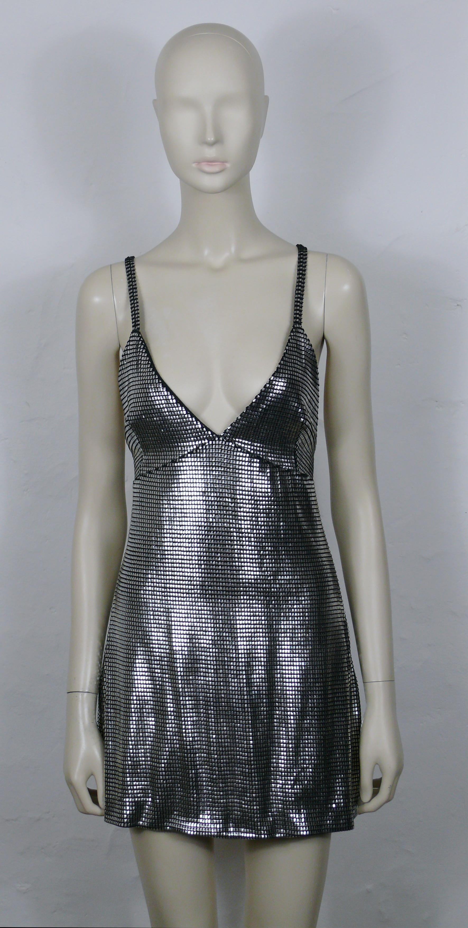 PACO RABANNE silver foil grid dress as worn by British Super Model KATE MOSS.

Top surface is silver foil printed creating a metallic chain mail effect on a black knit spandex base.

Cross back shoulder straps.

Label reads PACO RABANNE Paris.
Made