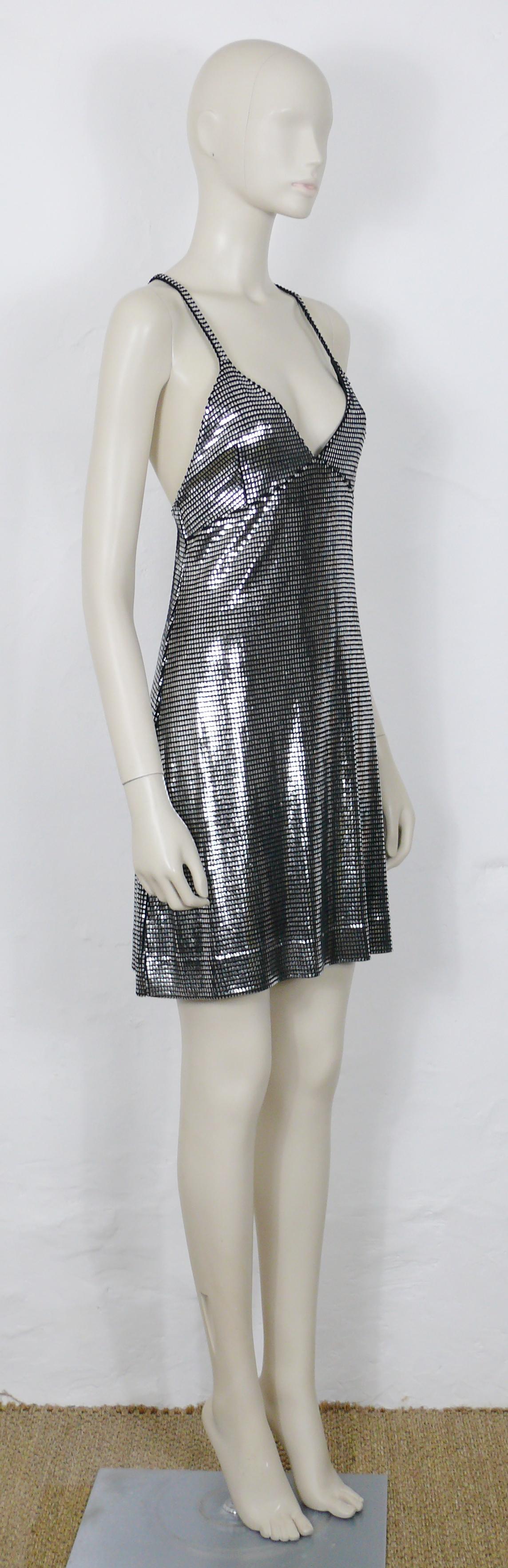 PACO RABANNE silver foil grid mini dress.

Top surface is silver foil printed creating a metallic chain mail effect on a black knit spandex base.

Cross back shoulder straps.

Label reads PACO RABANNE Paris.
Made in France.

Size tag reads :