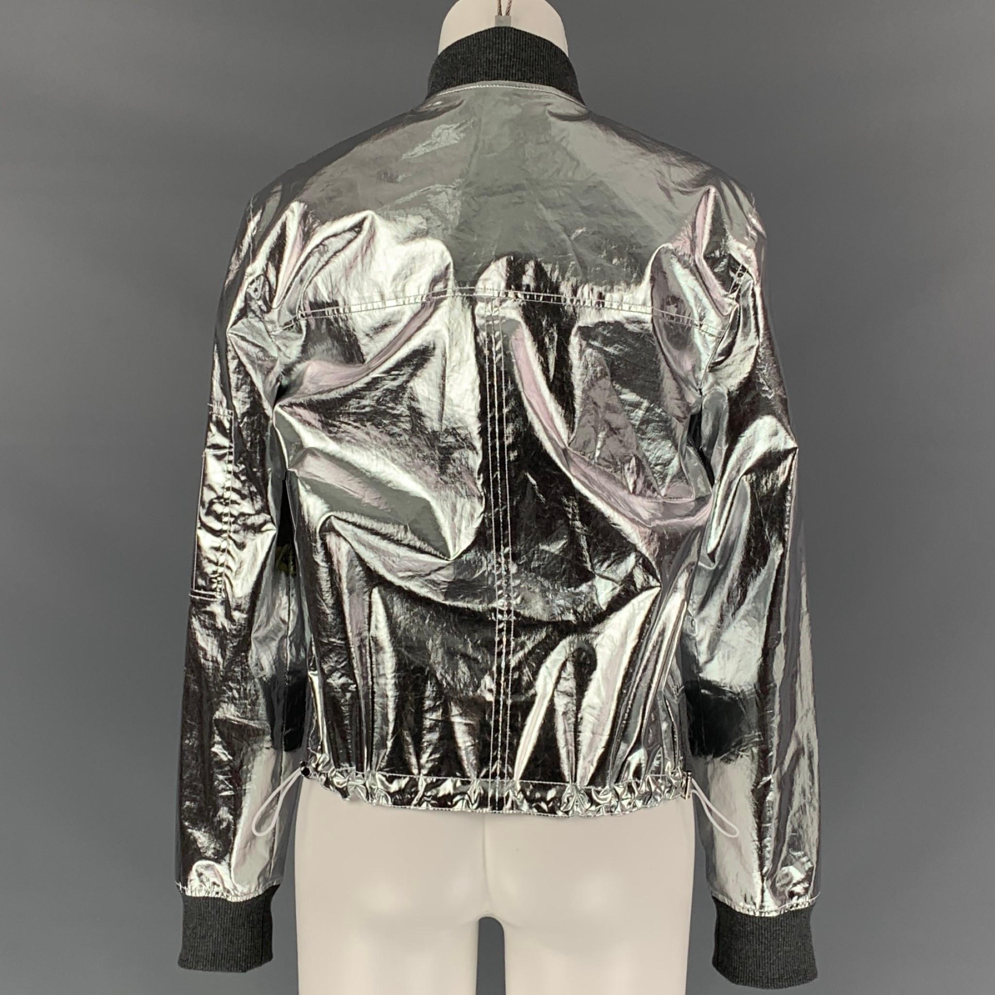 PACO RABANNE jacket comes in a silver metallic cotton / polyurethane featuring a bomber style, ribbed hen, cut out detail, slit pockets, and a full zip up closure. Made in Portugal. 

Very Good Pre-Owned Condition.
Marked: 38
Original Retail Price: