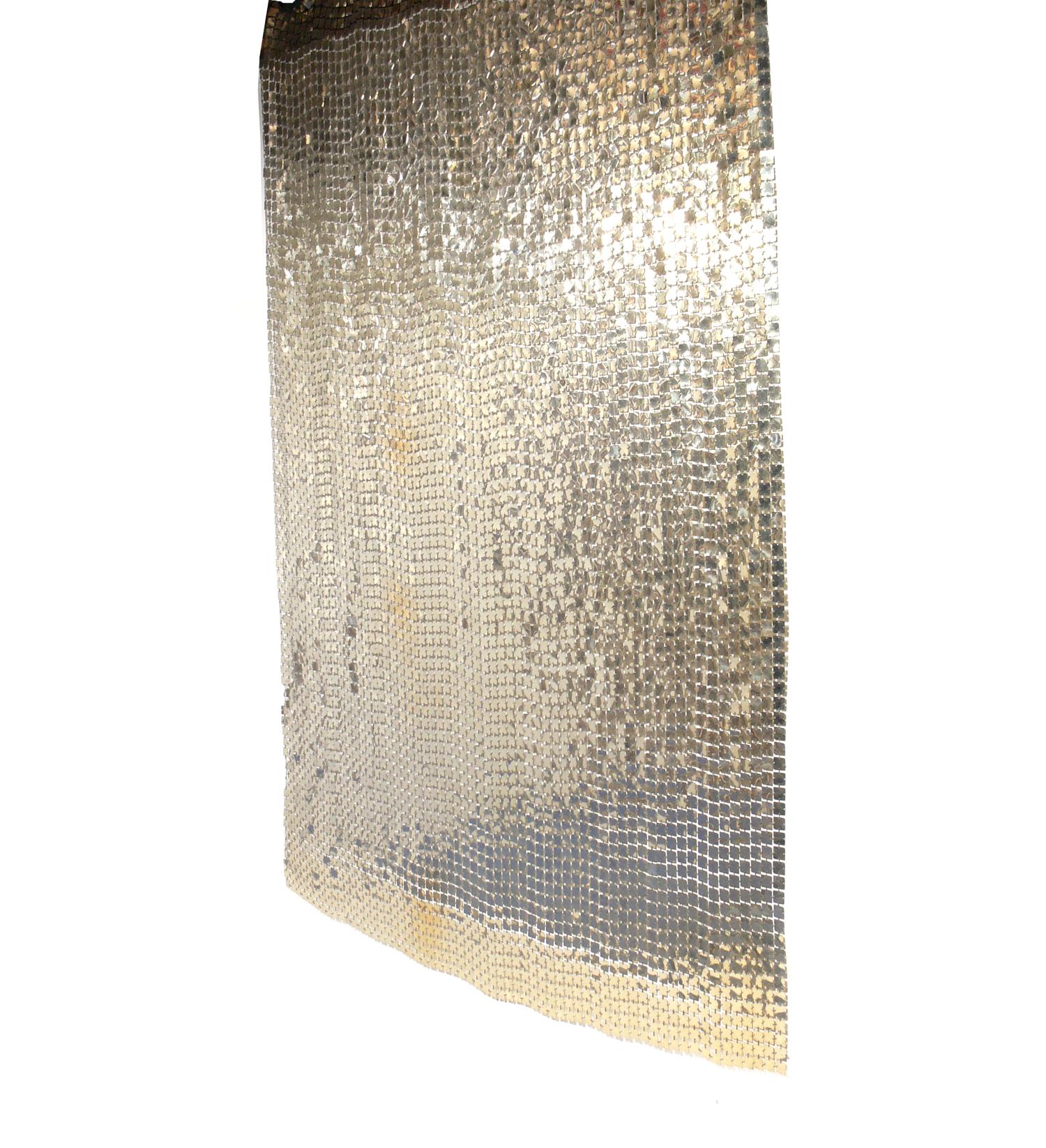 Paco Rabanne Space curtain or room divider, French, circa 1970s. It has a wonderful patinated aluminum color that looks more platinum or champagne color in certain light. Looks incredible when lit, as the discs reflect the light and gently move with