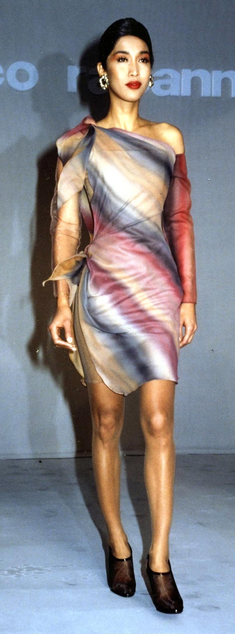 In a fleeting moment of pure sartorial poetry, Paco Rabanne defied his own reputation for armor-like futurism and delivered something ethereal, sensual, and utterly unforgettable. This gossamer dream from the Spring/Summer 1990 runway is an