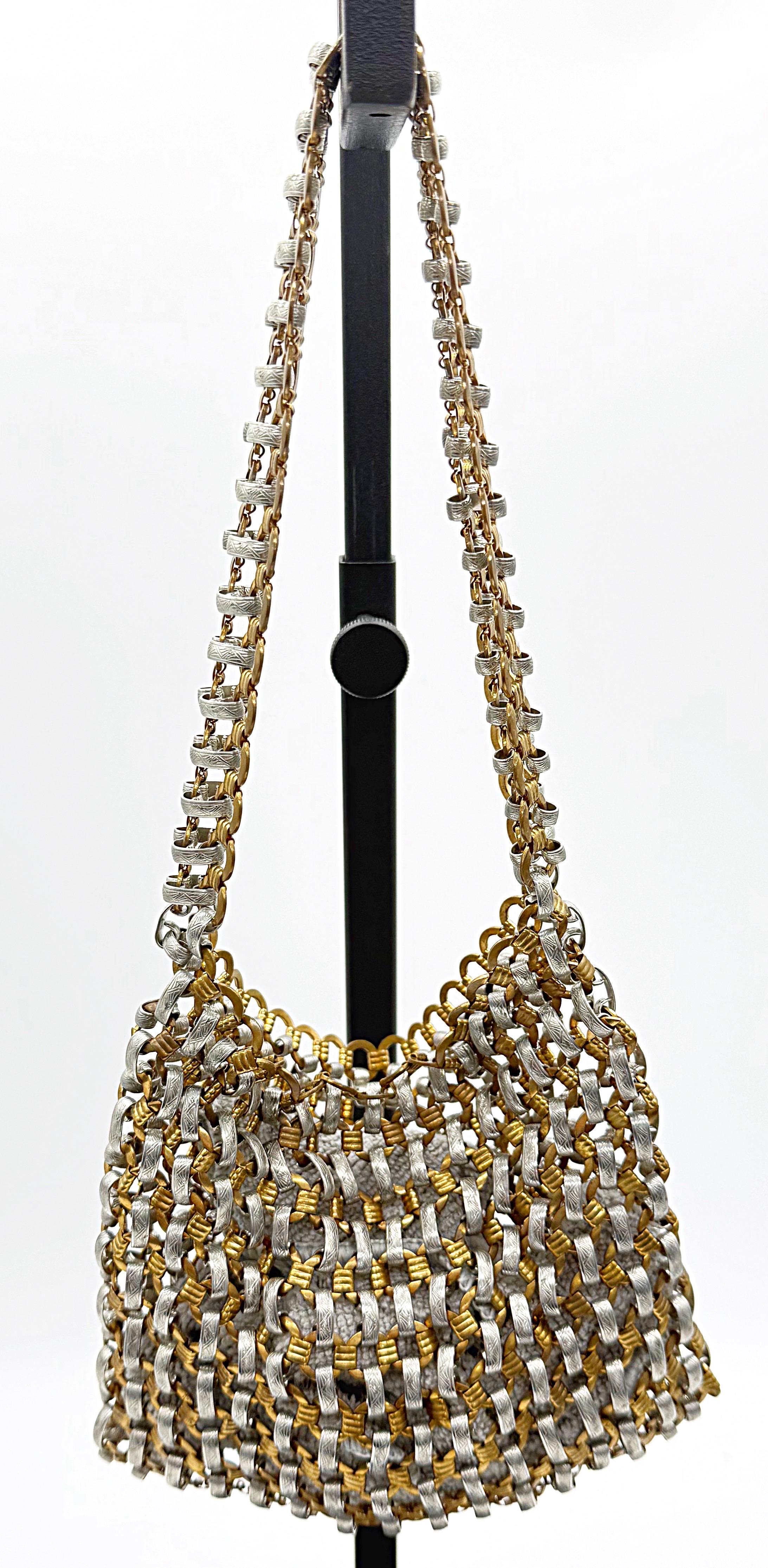 Rare and iconic 1960s Paco Rabanne gold and silver metal chain link evening bag ! A true statement piece that successfully completes any outfit. 
In great condition
Made in Italy
Measurements:
6.5 inches from side to side 
5.5 inches from top to