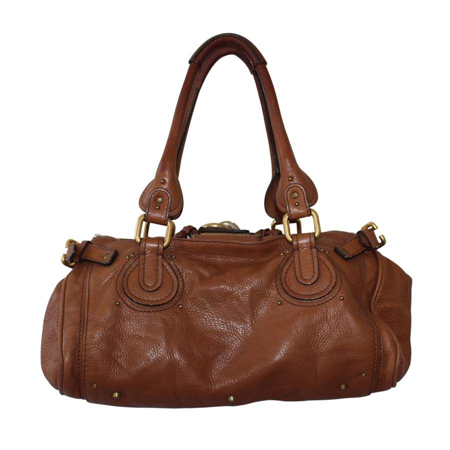 Leather Cognac color Two handles Big golden padlock with key Internal pocket with zip Zip closure Three other internal pockets Cm 36 x 17 x 19 (14.17 x 6.69 x 7.48 inches)
