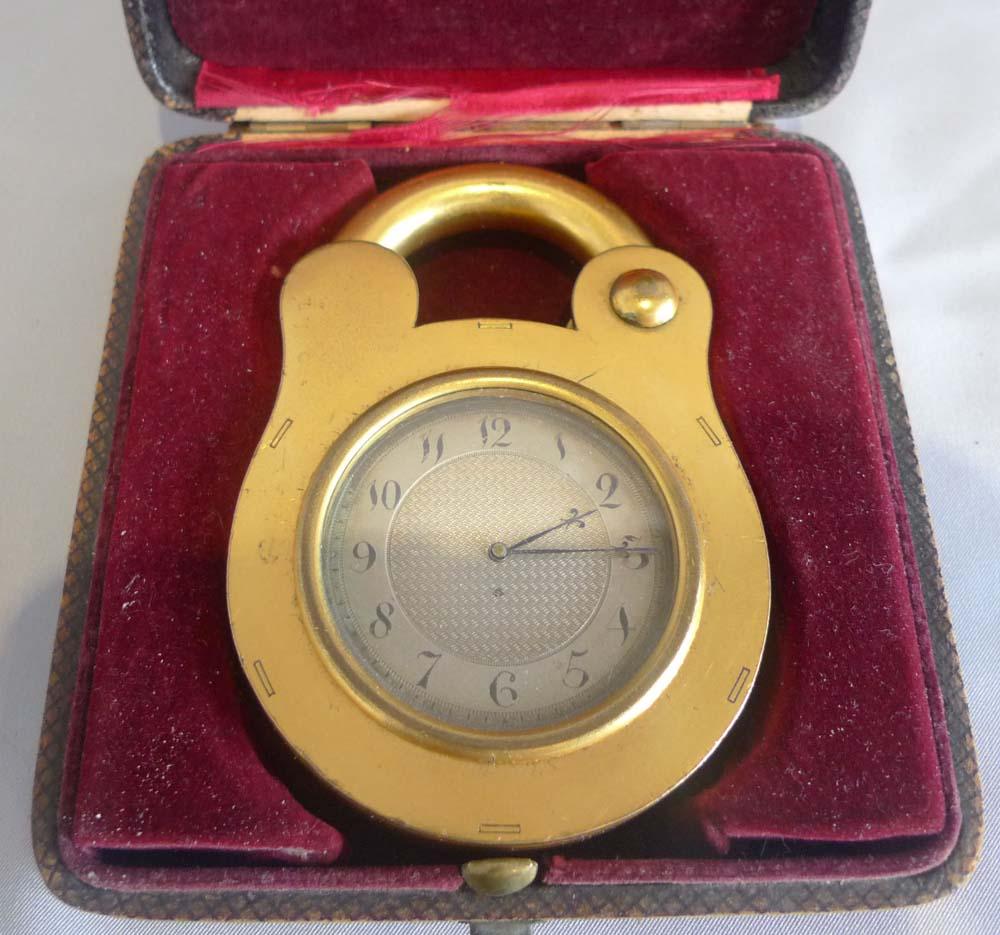 Unusual and rare boxed gilded bronze strut clock by the famous makers Howell James and Co. This strut clock is in the form of a padlock. The design was registered and the clock was illustrated in the Official Illustrated Catalogue of the