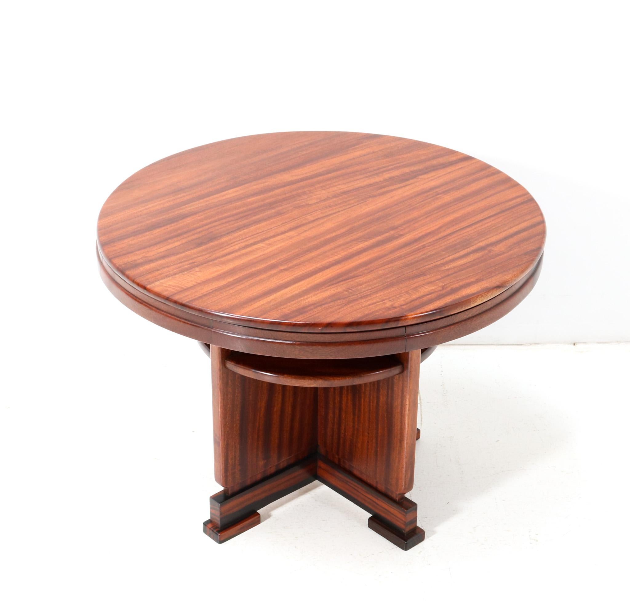 Stunning and rare Art Deco Amsterdamse School coffee table or cocktail table.
Striking Dutch design from the 1920s.
Solid padouk base with original padouk veneered top.
Solid macassar ebony and original macassar ebony veneered elements.
This