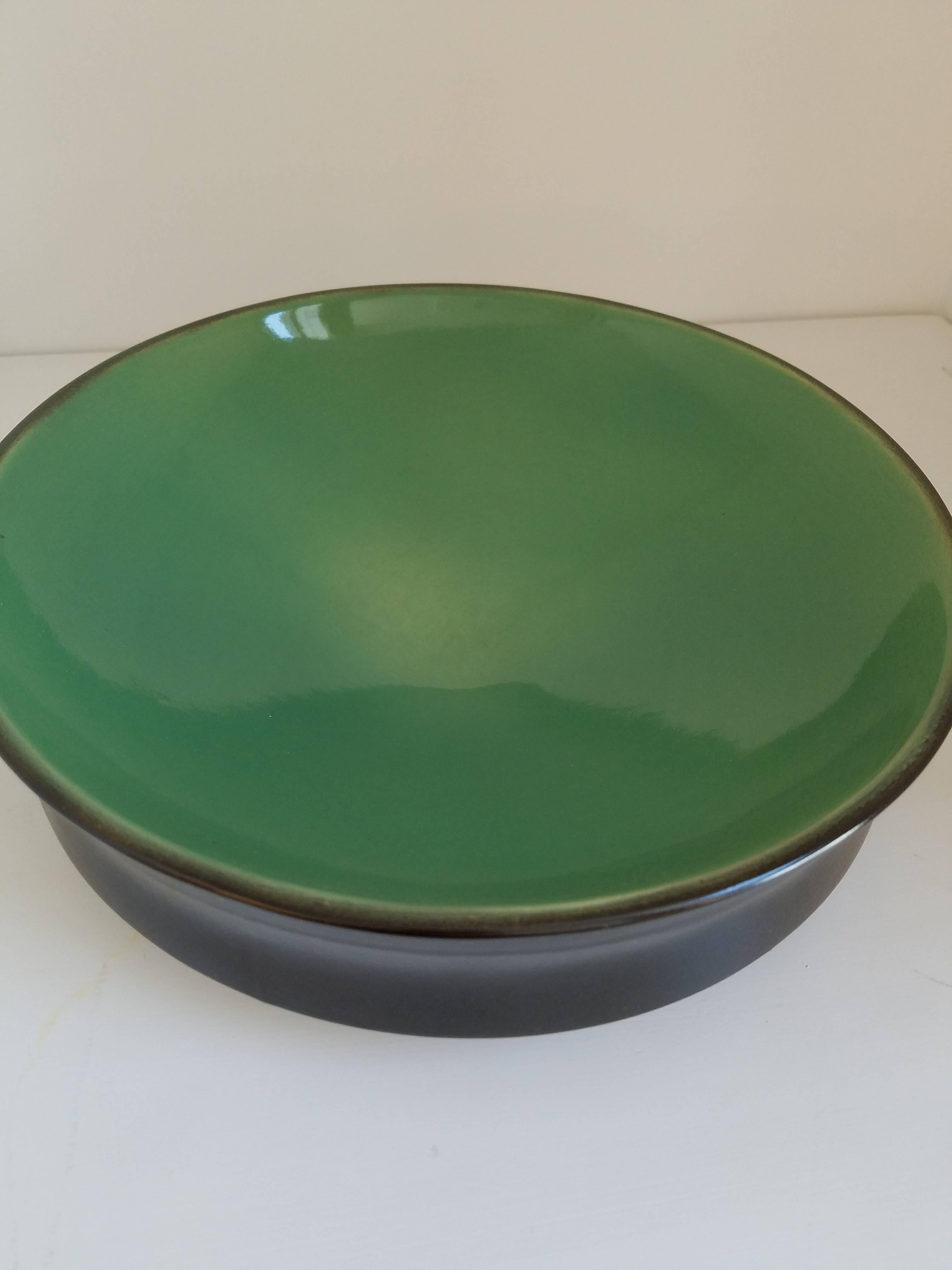 Hand thrown double glazed ceramic bowl with indented curved sides and contrast color glaze.
Details