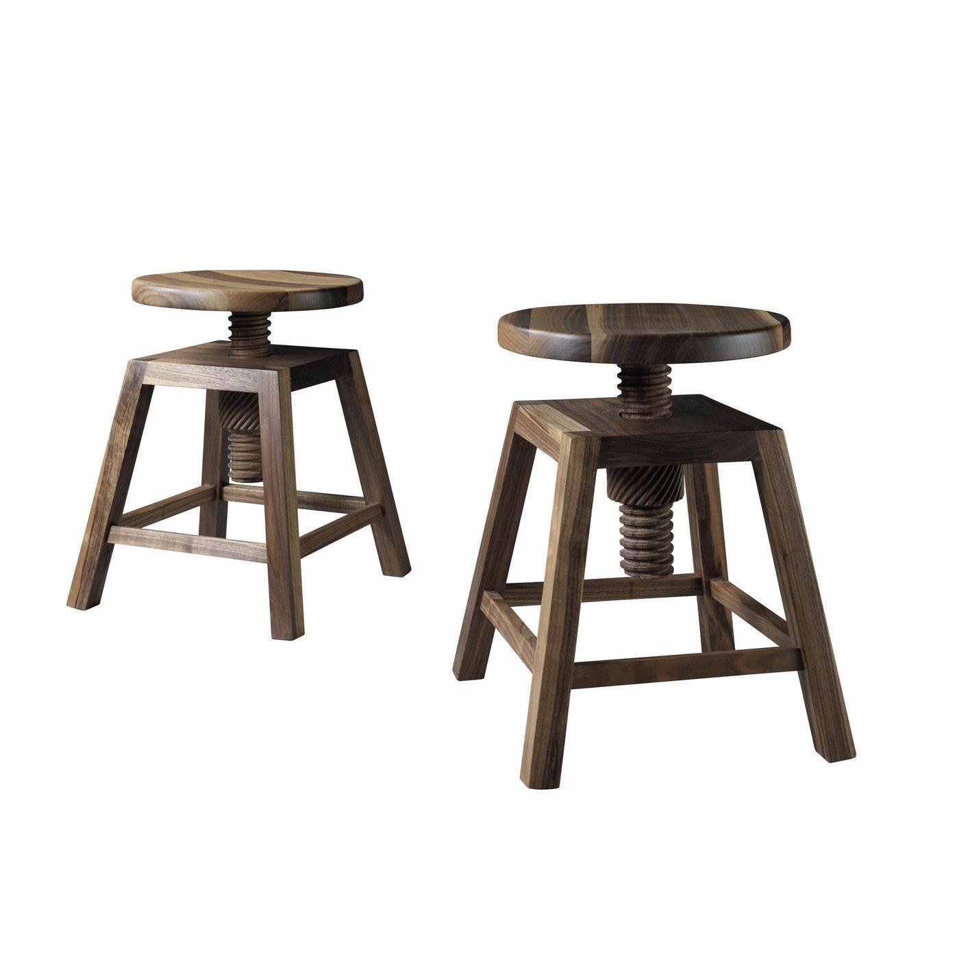 An exquisite wooden stool that puts a fresh twist on industrial-style seating, this piece offers a vintage, architectural look with a clean silhouette. Made of walnut with a natural finish that enhances its rich grain, this piece has a round swivel