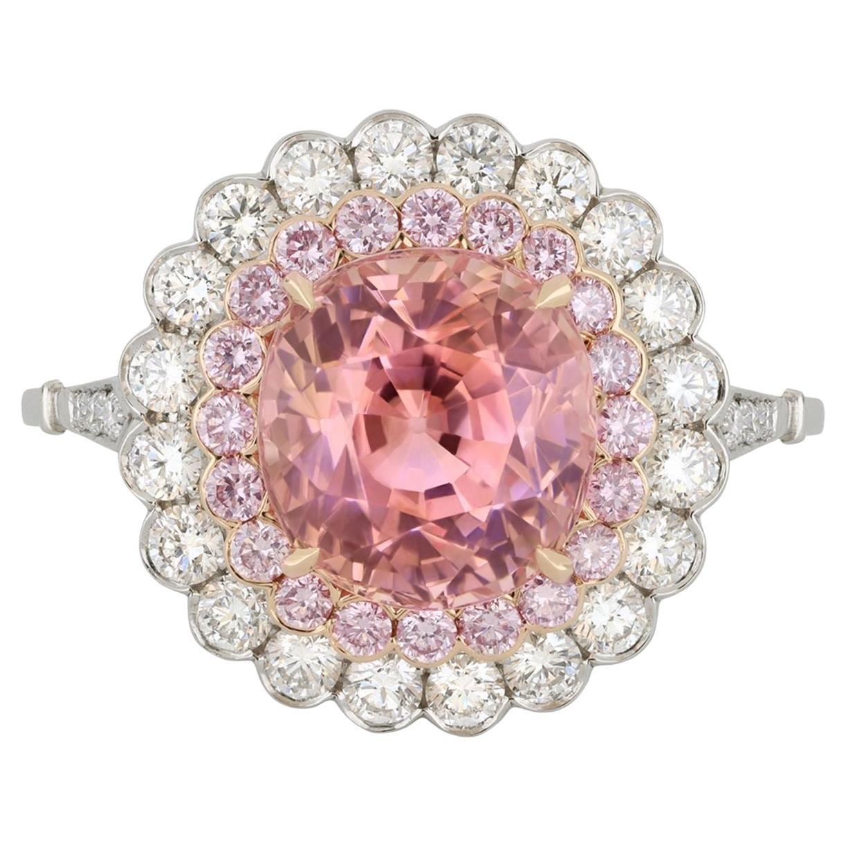 Padparadscha Ceylon sapphire and diamond cluster ring.