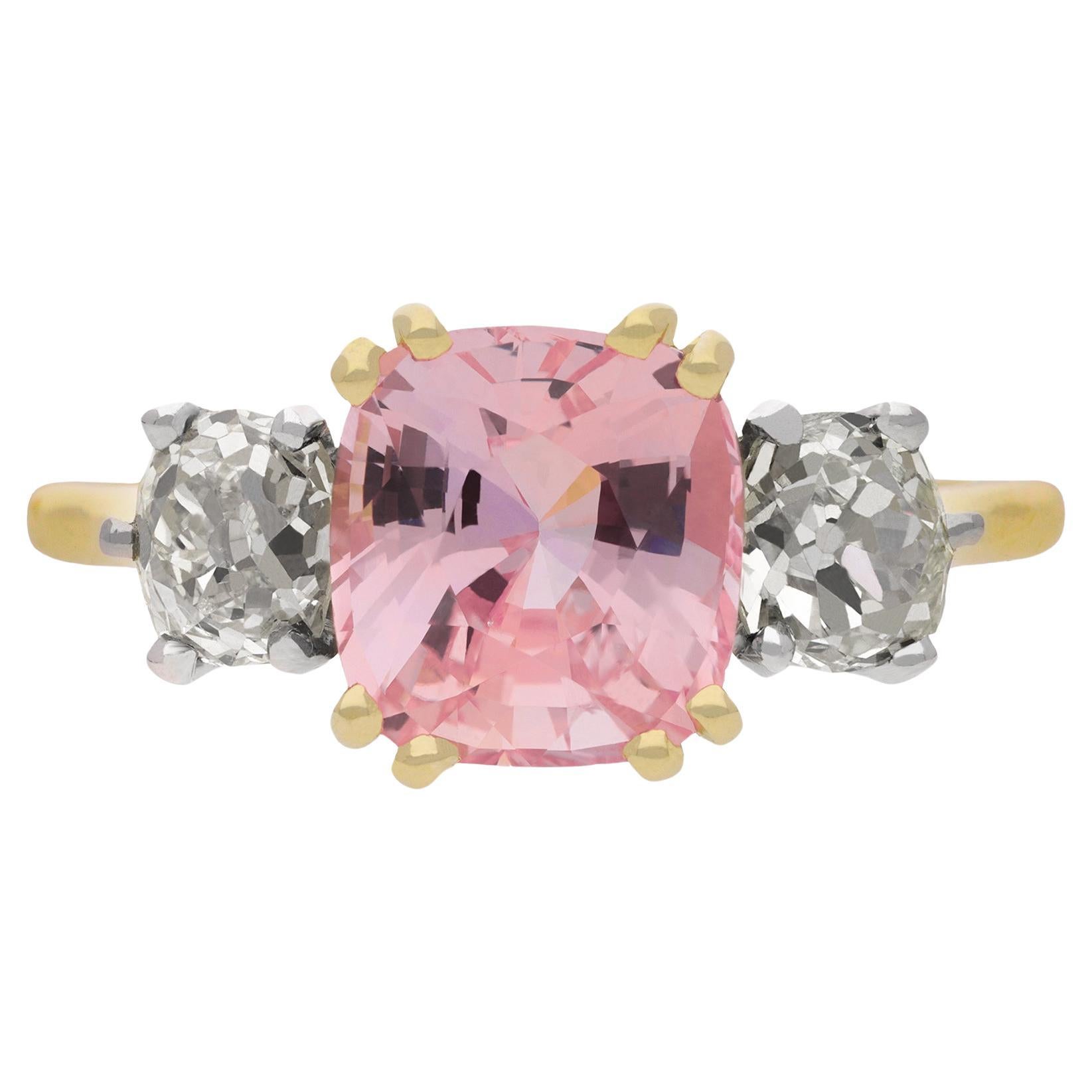 Padparadscha Ceylon sapphire and diamond three stone ring, circa 1915.