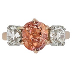 Padparadscha Ceylon sapphire and diamond three stone ring.