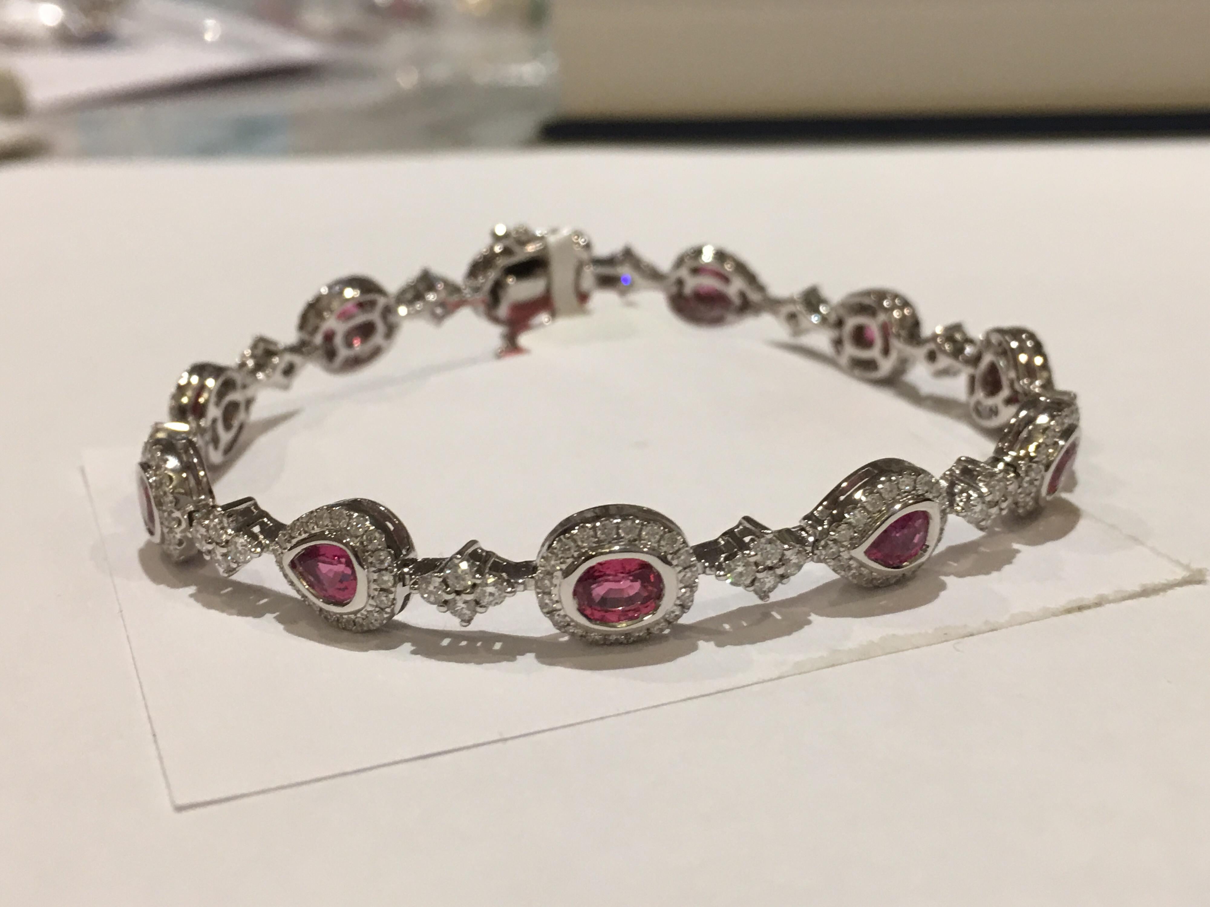 Natural Padparadscha Sapphire set in 14K White Gold. Total 5.10 Carat Padpardscha is IGL Certified  stones.
Round white diamonds 2.04 Carat is VS quality D /E Color.
One of a kind hand crafted Bracelet is 7 Inches Long.

