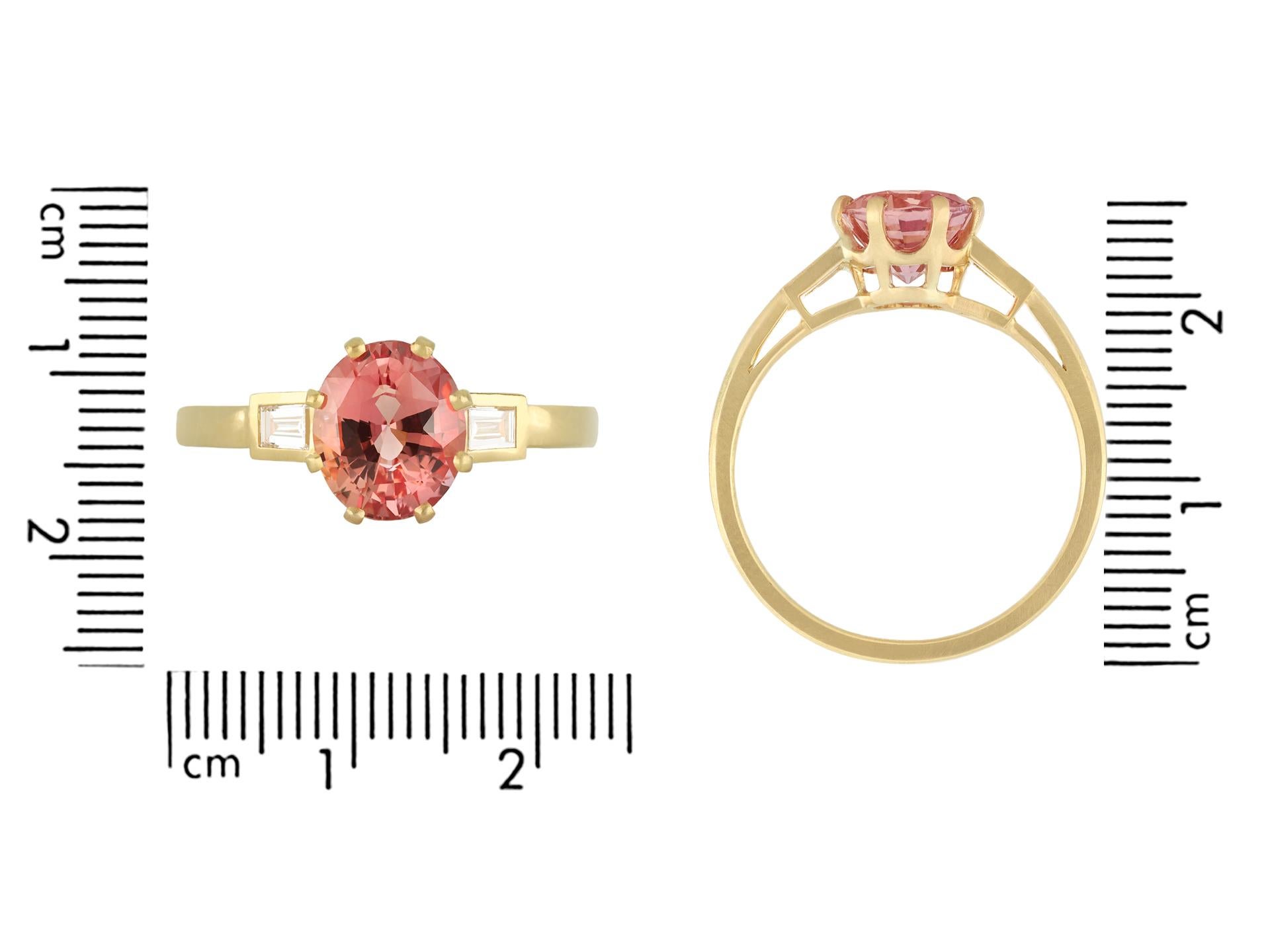 Padparadscha sapphire and diamond flanked solitaire ring, circa 1990. In Good Condition For Sale In London, GB