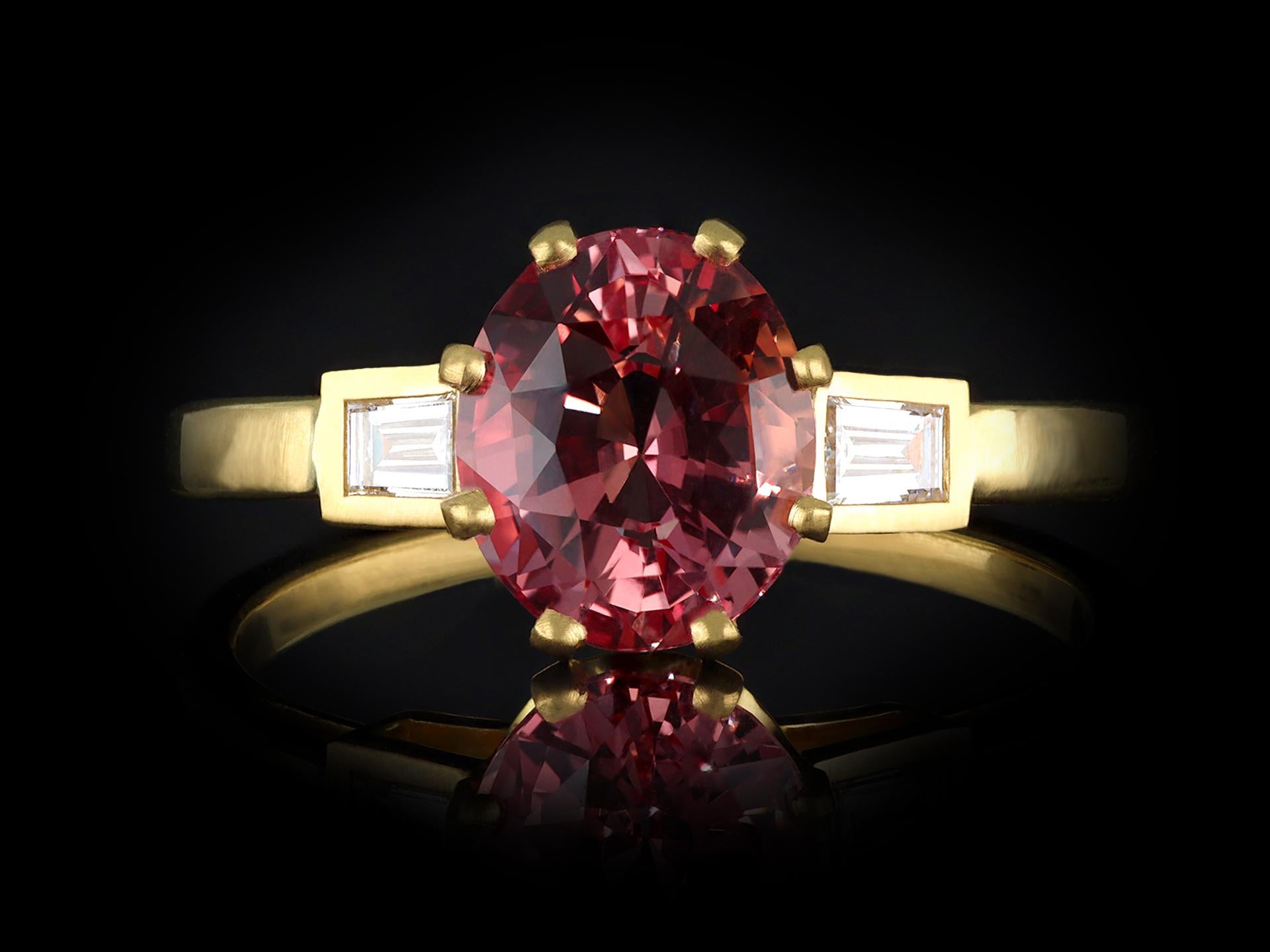 Women's Padparadscha sapphire and diamond flanked solitaire ring, circa 1990. For Sale