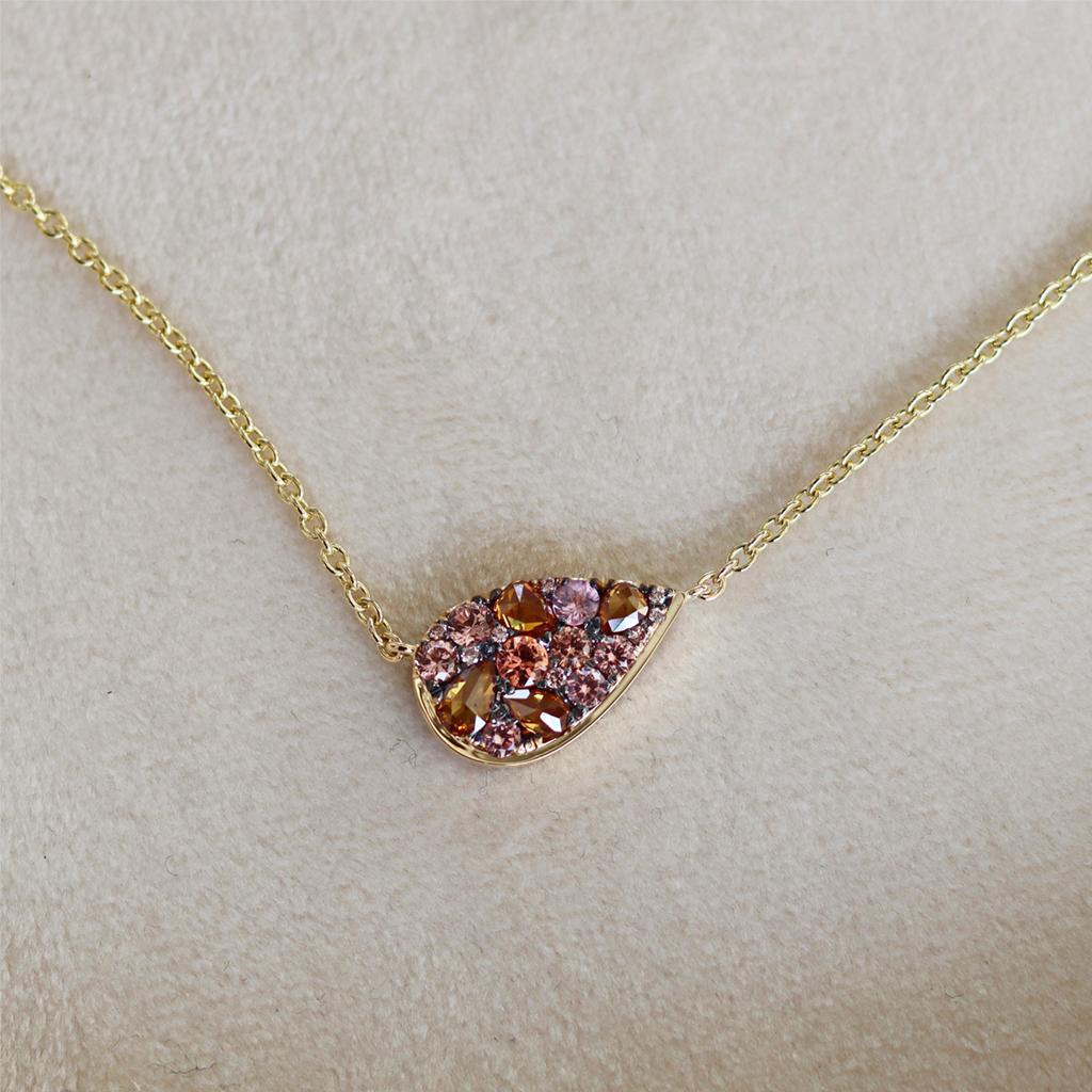 One of a kind Pendant with necklace handmade ( no casting involved) in Belgium by jewellery artist Joke Quick in 18K yellow gold 4.7 g pave set with 8 unheated Padparadscha sapphires from Madagascar 0,40 ct., 4 X Fancy Cognac rose-cut diamonds 0,34