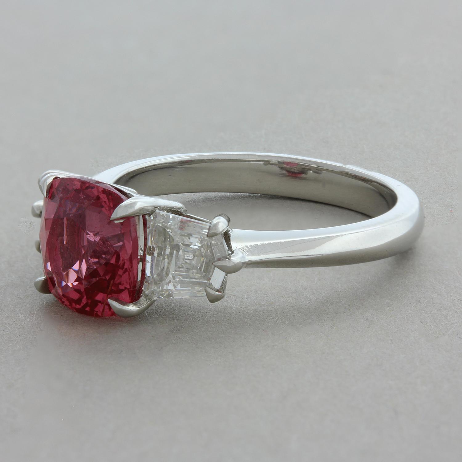 A true collectors pieces this ring features a rare orangy pink Padparadscha sapphire weighing 3.03 carats. Certified by the GIA as a true Padparadscha this rare stone is difficult to find in sizes 3 carats and above. It is accented by two shield cut