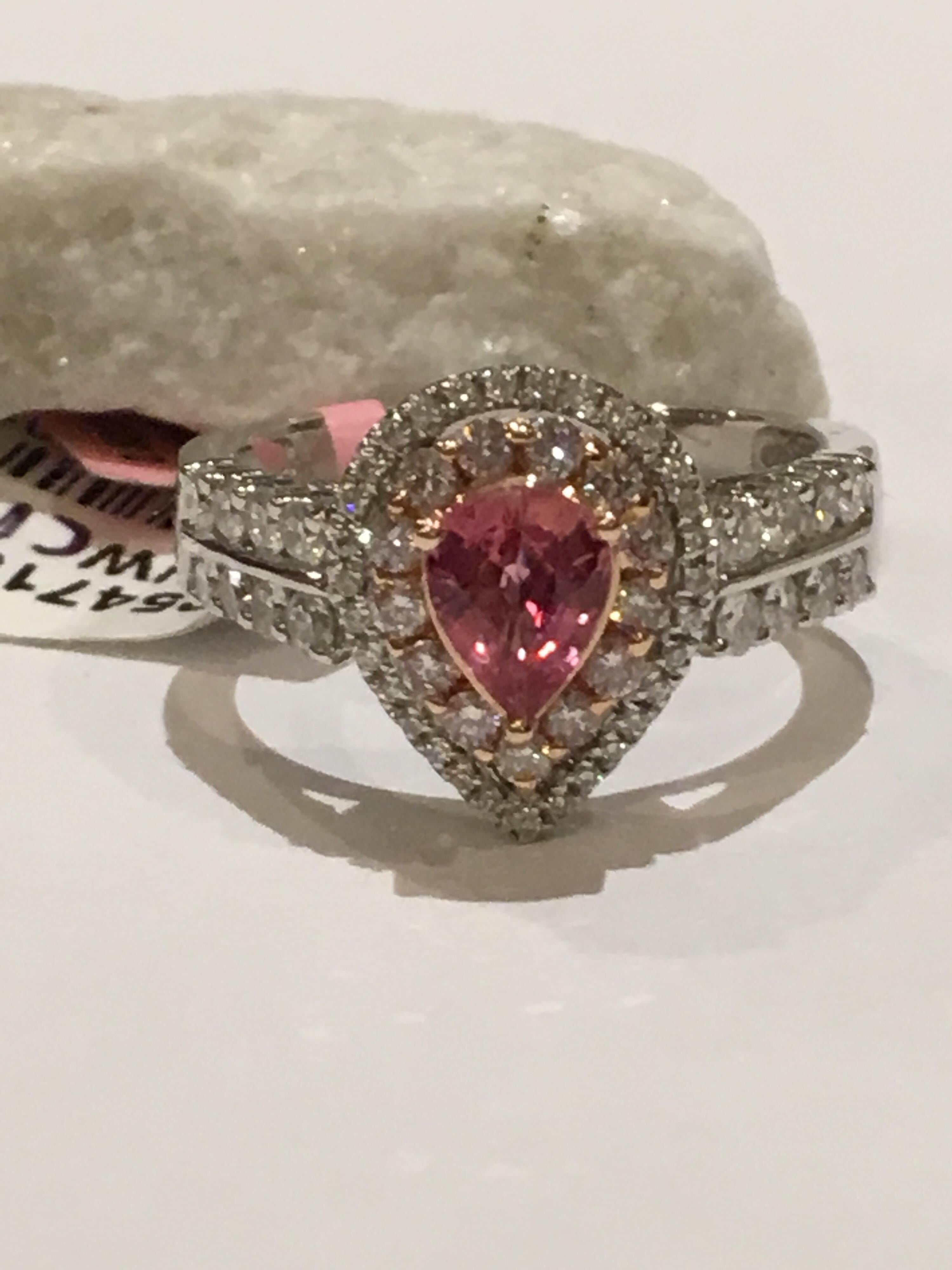 Natural Padparadscha Sapphire set in 14K Two tone Gold.
Padaparadscha Sapphire weigh 0.80 Carat and 0.53 Carat White Diamonds and and 0.24 Carat Pink Diamonds.
The size of the Ring is 7 and can be resized.